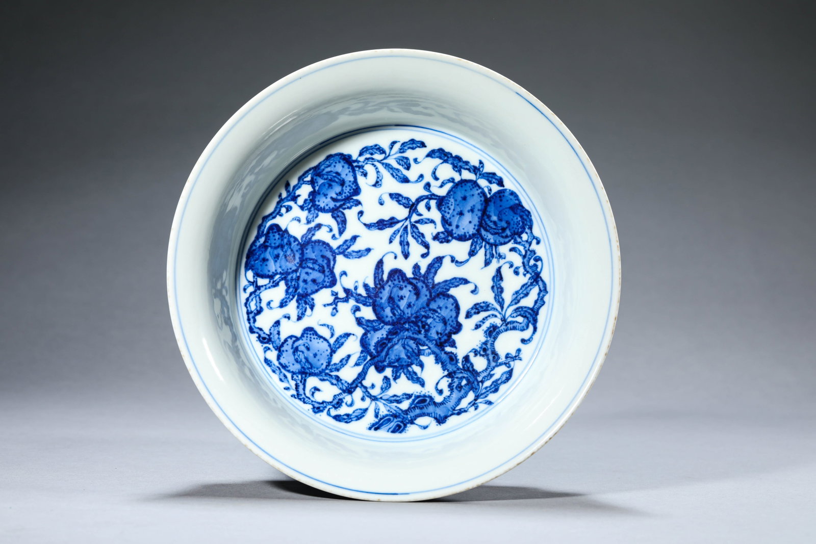 A Blue and White 'Interlocking Lotus, Bat and Shou' Brush Washer: Dimensions: Width: 22.2 cm (8.74 in) x Height: 6.5 cm (2.56 in). All measurements are approximate.