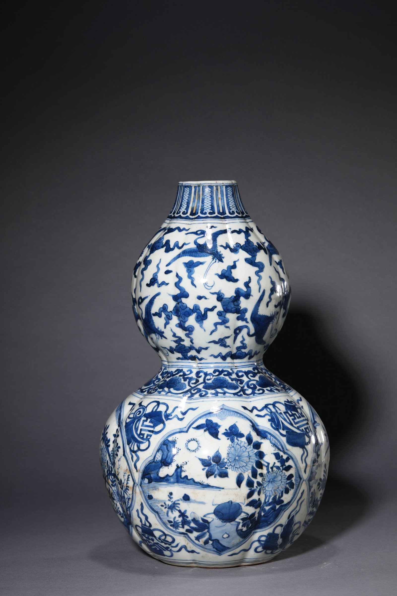 A Blue and White 'Eight Emblems, Flowers and Birds' 'Melon-Lobed Double-Gourd' Vase (1 of 8)