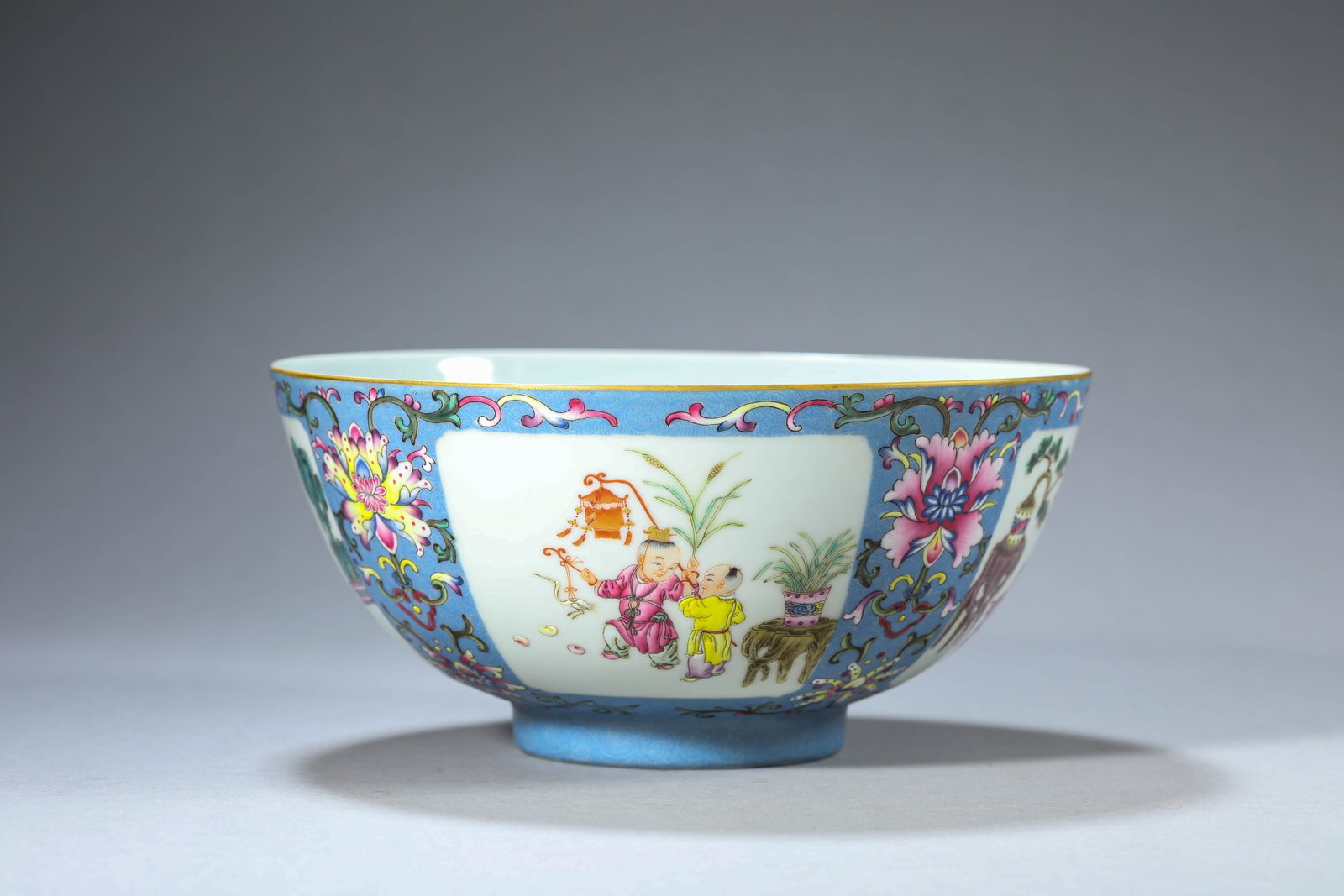 A Blue-Ground Famille-Rose 'Children at Play Reserves' Bowl: Dimensions: Width: 18.8 cm (7.40 in) x Height: 9.1 cm (3.58 in). All measurements are approximate.