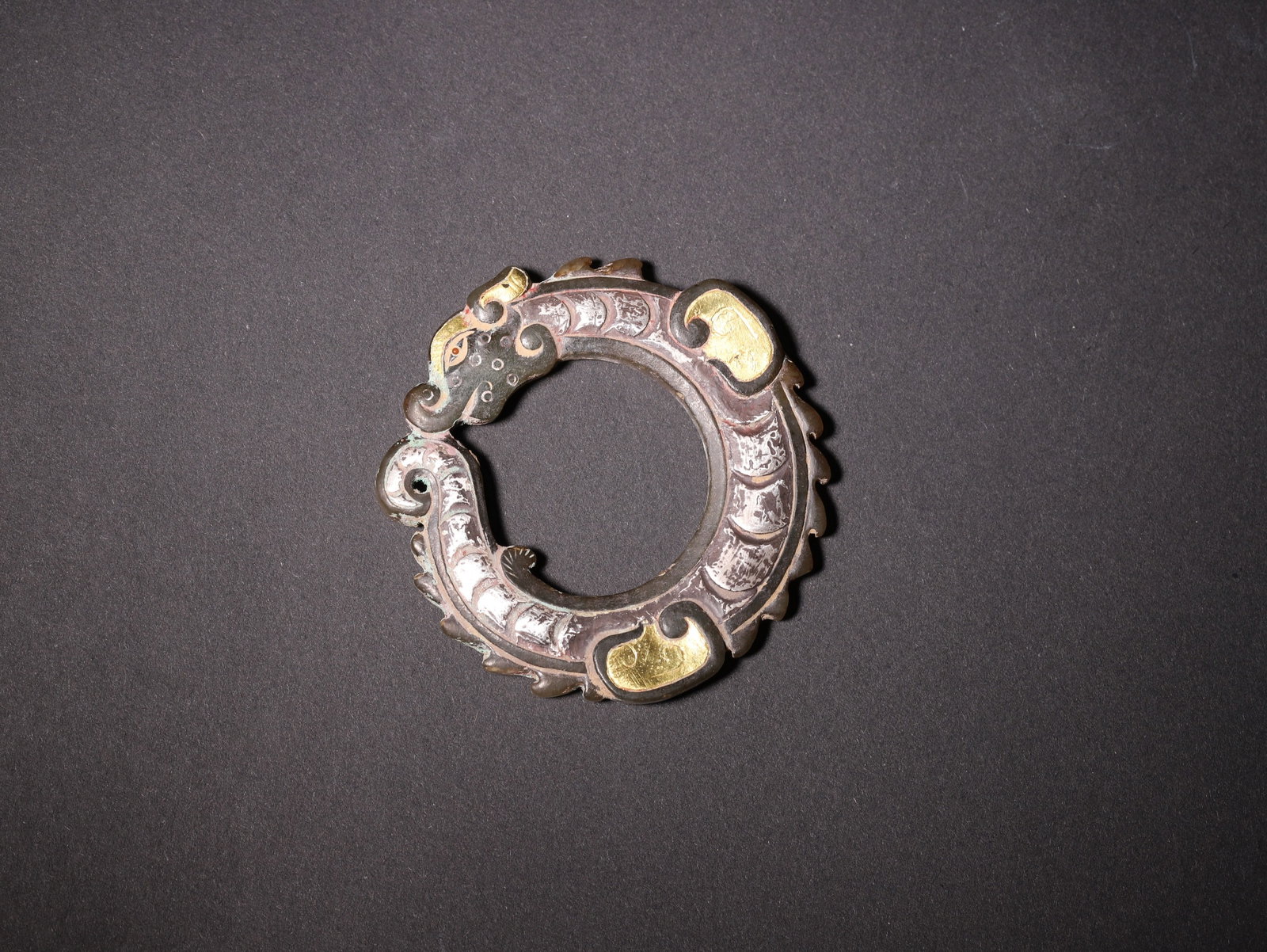 A Bronze Gold and Silver Inlaid C-Shaped Dragon Pendant, Han Dynasty (1 of 5)
