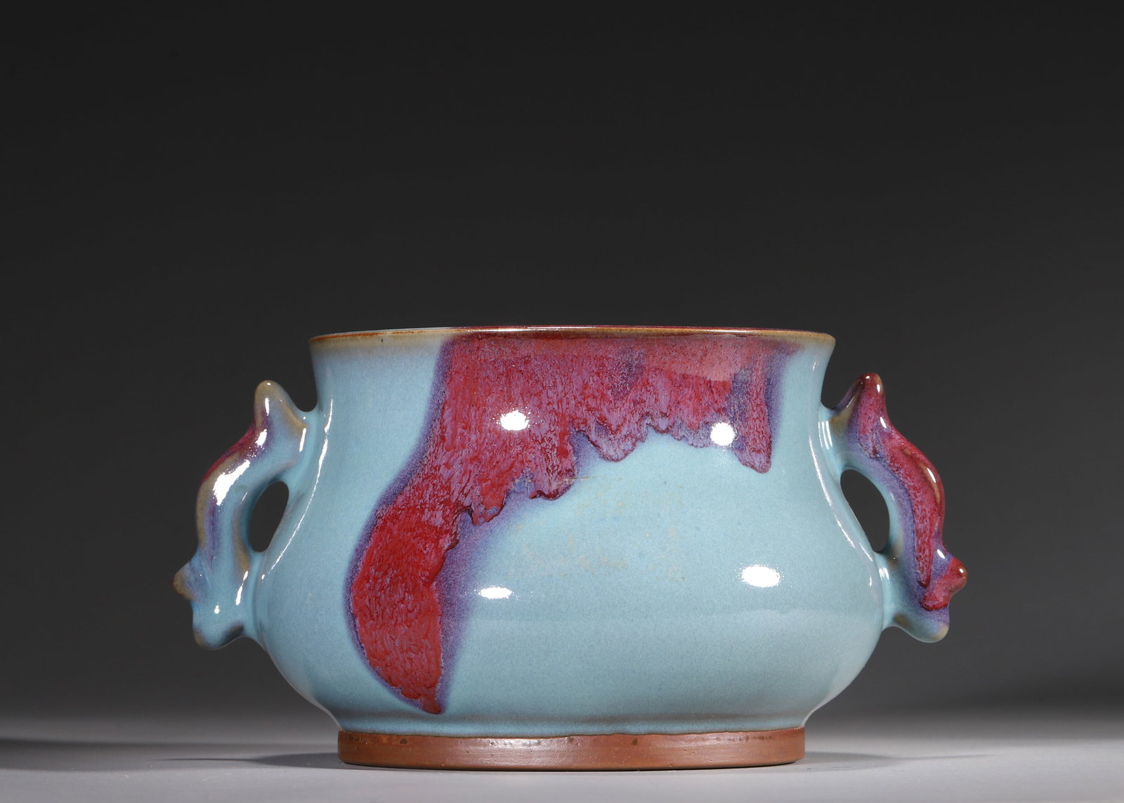 A Junyao Sky Blue Glazed Censer with Rose Purple Splashes, Song Dynasty: H 10.0cm (3.94 in); L 19.0cm (7.48 in); W 15.0cm (5.91 in)A Song dynasty Junyao censer with elegant form, covered in lustrous sky blue glaze with naturally flowing rose purple splashes. The reddish-br