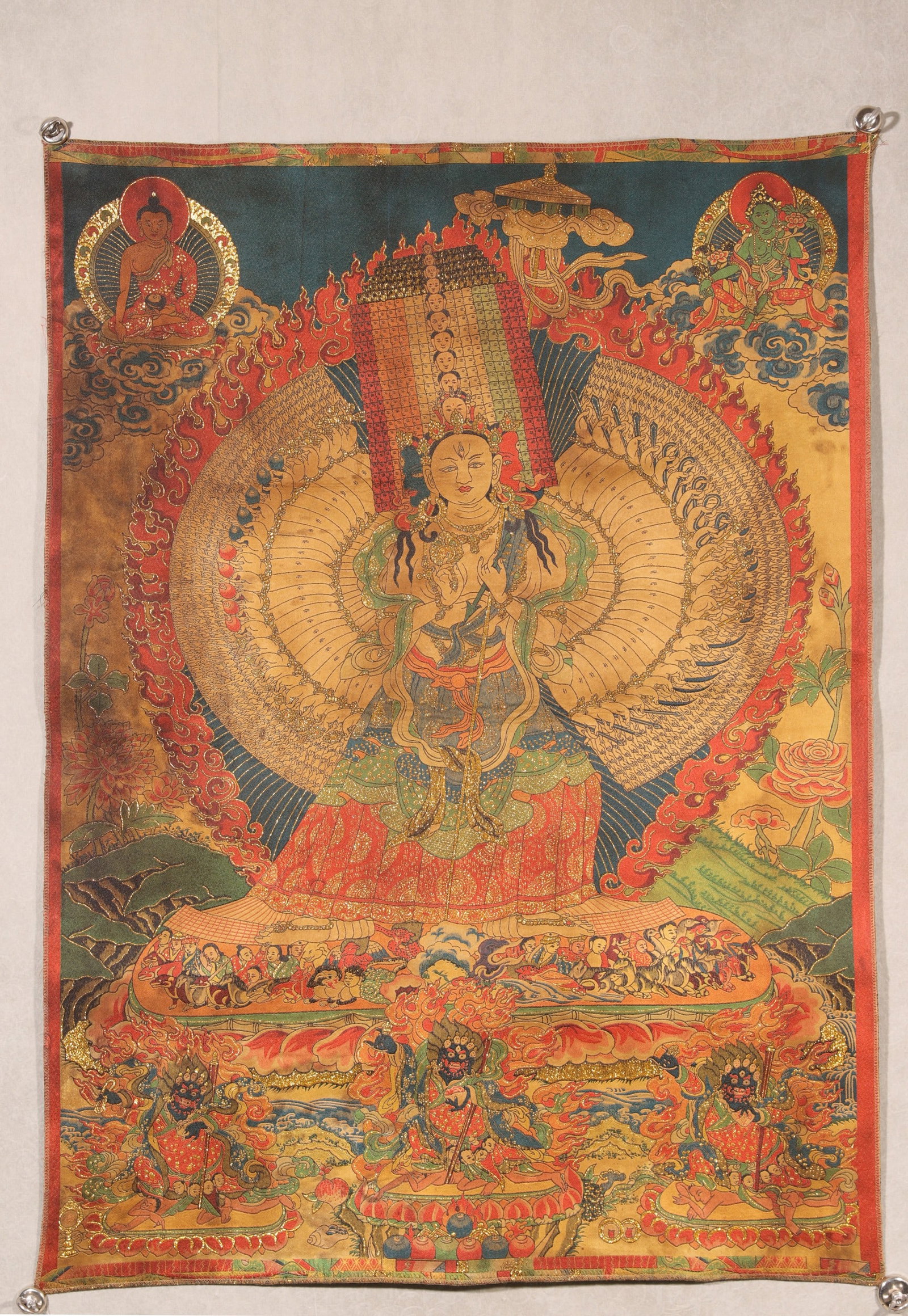 An Embroidered Thangka of Sitatapatra, Qing Dynasty: L 102.0cm (40.16 in); W 72.0cm (28.35 in)An embroidered thangka of Sitatapatra from the Qing Dynasty, featuring the serene yet powerful White Umbrella Goddess with thousand arms and eyes. Crafted with