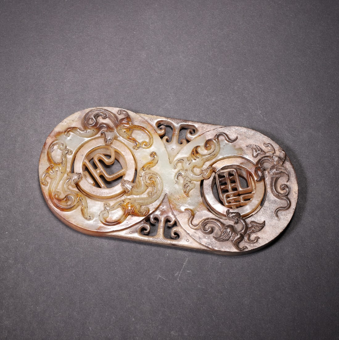 An Ancient Jade Openwork Dragon and Phoenix Spinning Pendant - Warring States to Han Dynasty: Length 12.0cm (4.72 in); Width 6.0cm (2.36 in); Weight 165.0g (0.36 lb)An exquisite ancient jade spinning pendant from the Warring States to Han Dynasty. Crafted with openwork dragon and phoenix motif