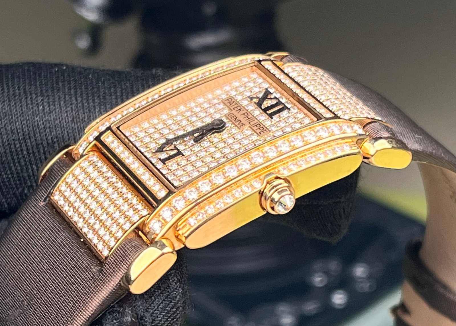 PATEK PHILIPPE 18K ROSE GOLD LADIES' QUARTZ WATCH: 18K rose gold case, 30x24.9mm case diameter, dial adorned with radial sunburst pattern, set with original diamonds, powered by a quartz movement for precise and stable timekeeping