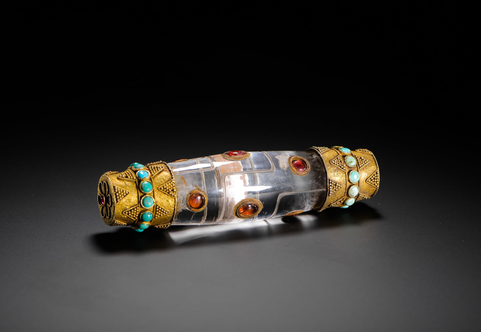 QING DYNASTY CRYSTAL GILDED AND GEM-INLAID RITUAL VESSEL: H:13cm(5.12in) D:3.5cm(1.38in) Weight:210g(0.46lb)This is a Qing Dynasty Tibetan Buddhist ritual implement, made primarily of natural crystal in a multi-segmented cylindrical form. Both ends are gilde
