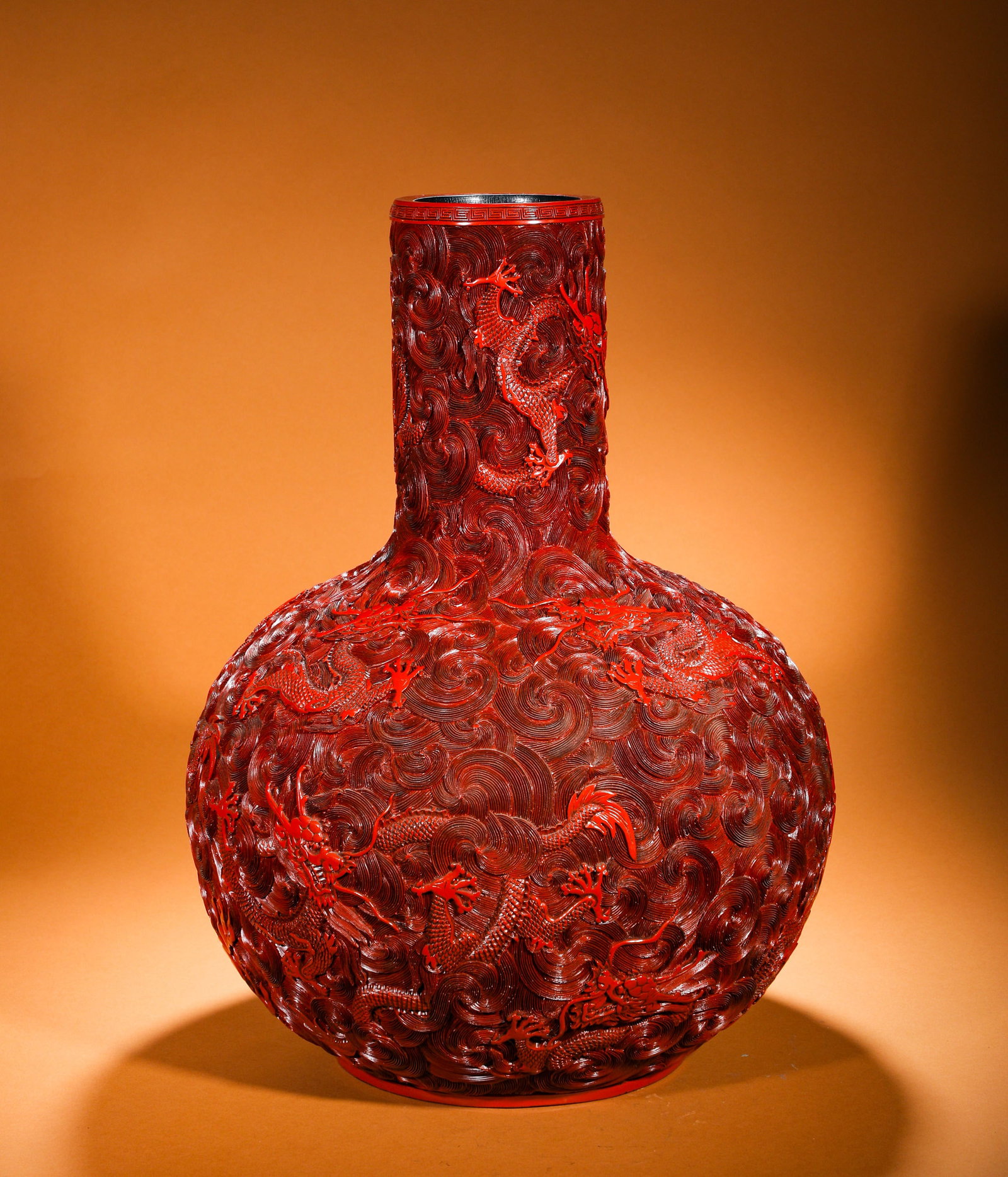 A RED SEA WATER DRAGON PATTERN CELESTIAL GLOBE VASE WITH THE INSCRIPTION OF EMPEROR QIANLONG OF THE: Height:60cm(23.62in) Width:44cm(17.32in) Weight:6570g(14.48lb)Qing Dynasty Qianlong-marked carved red lacquer celestial sphere vase. Wooden core with thick red lacquer deep relief carving of nine drag
