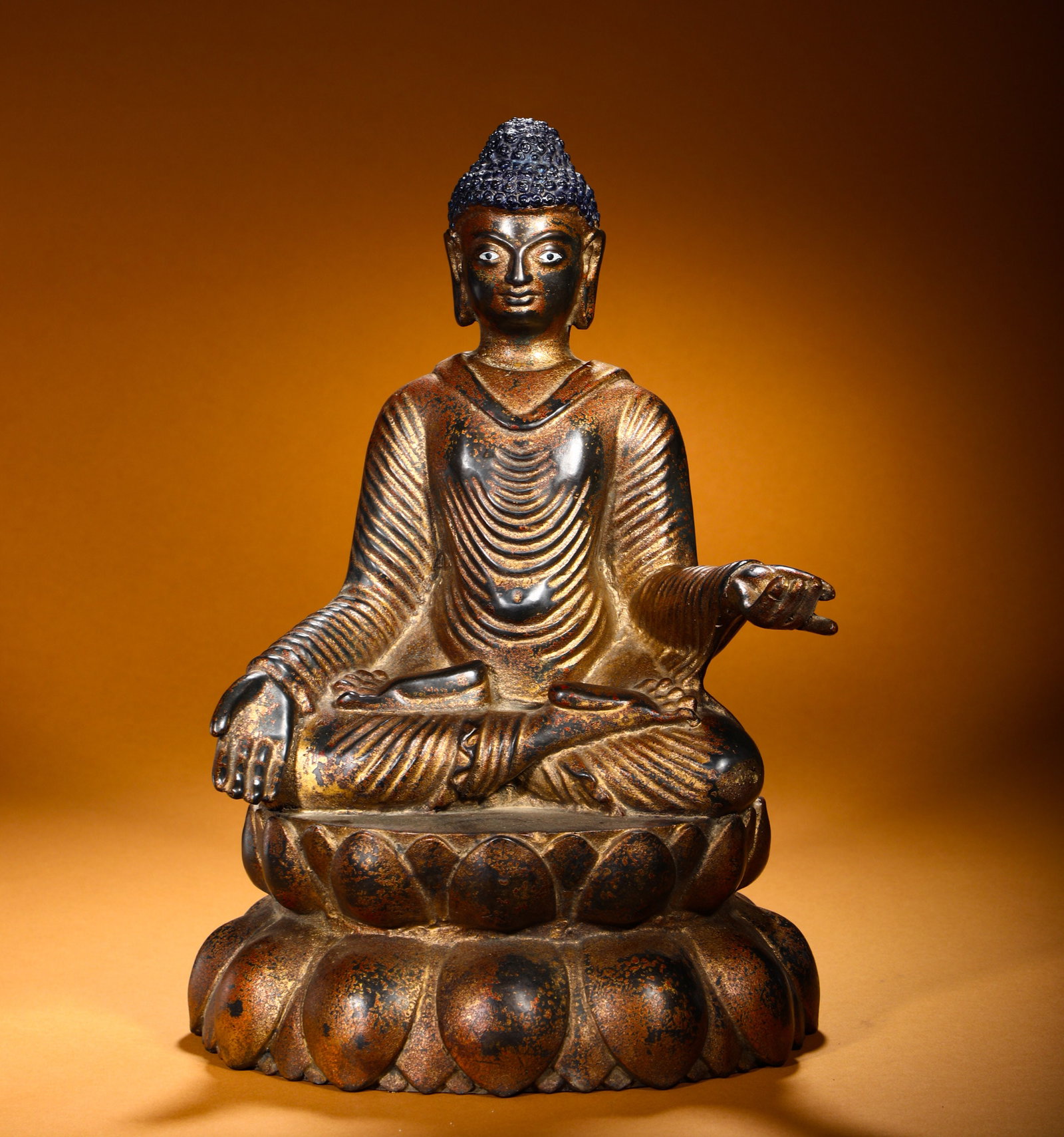 QING DYNASTY GILDED BRONZE STATUE OF SAKYAMUNI ATTAINING ENLIGHTENMENT AND SITTING BUDDHA: Height:38cm(14.96in) Width:27cm(10.63in) Weight:6670g(14.70lb)Gilt bronze seated Buddha Shakyamuni statue. Bronze base with worn gold gilding layer. The Buddha sits cross-legged on double lotus pedest