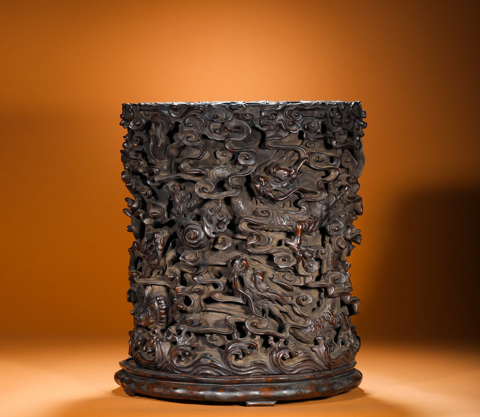 QING DYNASTY ROSEWOOD CARVED NINE DRAGONS IN THE SEA PIERCED PEN HOLDER: Height:34cm(13.39in) Width:29cm(11.42in) Weight:8650g(19.07lb)Qing Dynasty solid hardwood red sandalwood hollowed brush pot with nine dragons amid waves carving, matching original timber base. Each ho