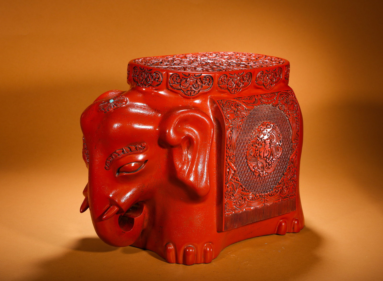 QING DYNASTY RED LACQUERED TAIPING ELEPHANT SITTING PEDESTAL: Height:35cm(13.78in) Width:53cm(20.87in) Weight:660g(1.46lb)Red carved lacquer elephant-shaped stool of the Qing Dynasty, symbolizing peace and prosperity. The whole piece is crafted with scarlet carv