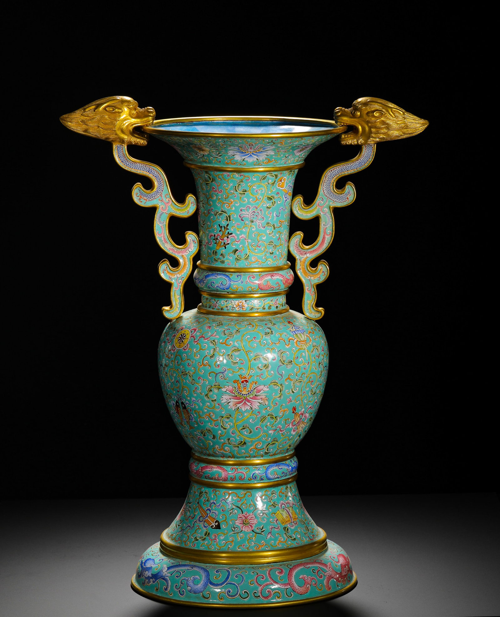 QING QIANLONG COPPER-PAINTED ENAMEL FLOWER : Height:52cm(20.47in) Width:38cm(14.96in) Weight:4580g(10.10lb)Qing Qianlong large bronze painted enamel gu vase with eight treasures, dragon & phoenix scrolls on turquoise ground. Gilded borders all o
