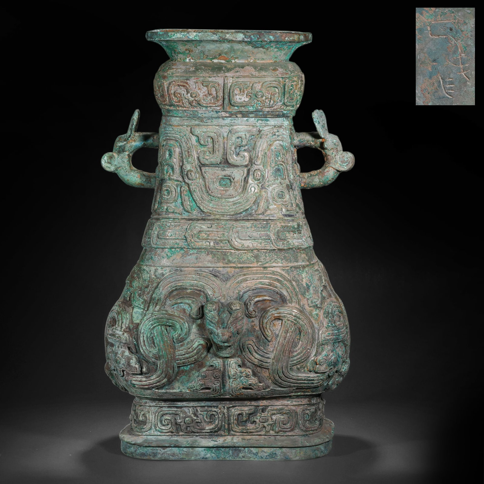 SHANG DYNASTY BRONZE DOUBLE-EARED POT WITH ANIMAL FACE PATTERNS: H:58.0cm(22.83in) W:34.0cm(13.39in) Weight:17250g(38.03lb)This vessel is cast in bronze, with a wide mouth, narrow neck, sloping shoulders, bulging belly and square base, and symmetrical beast-head