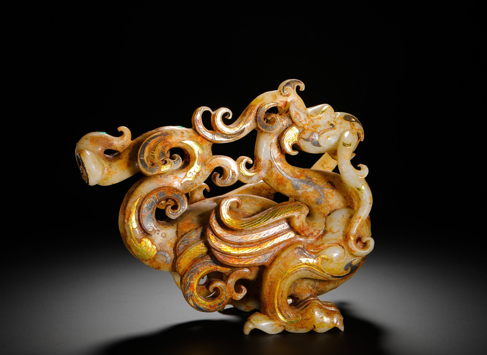 HAN DYNASTY HETIAN JADE INLAID WITH GOLD AND SILVER DRAGON AND PHOENIX AUSPICIOUS BEASTS: Height:16cm(6.30in) Width:21cm(8.27in) Weight:2210g(4.87lb)Han Dynasty ornament carved from Hetian jade with gold and silver inlaid phoenix-dragon design. The white jade bears natural burial patina, f