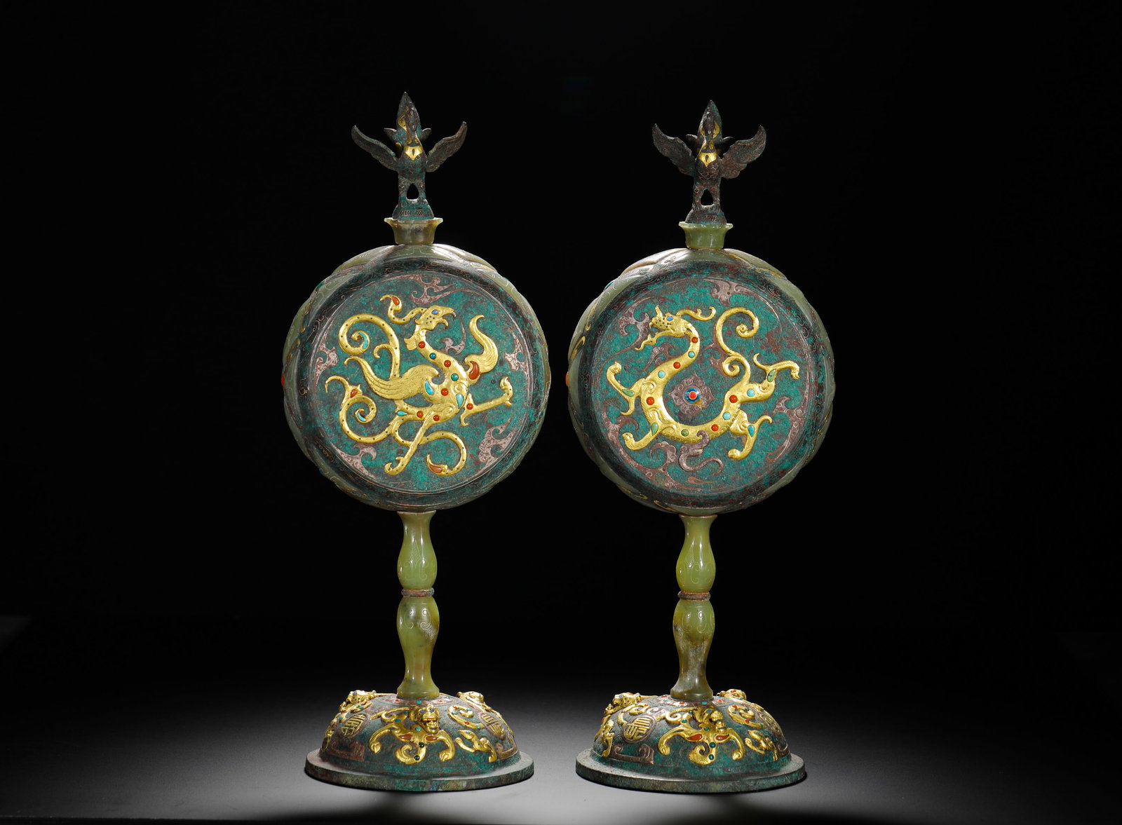 BRONZE LAMPS WITH INLAID GOLD AND SILVER INLAID WITH TURQUOISE AND DRAGON AND PHOENIX PATTERNS FROM: H:33cm (12.99in) W:12cm (4.72in) Weight:2710g (5.97lb) This pair of lamps are Warring States Period lighting utensils. Decorated with intricate dragon and phoenix patterns inlaid with gold, silver, an