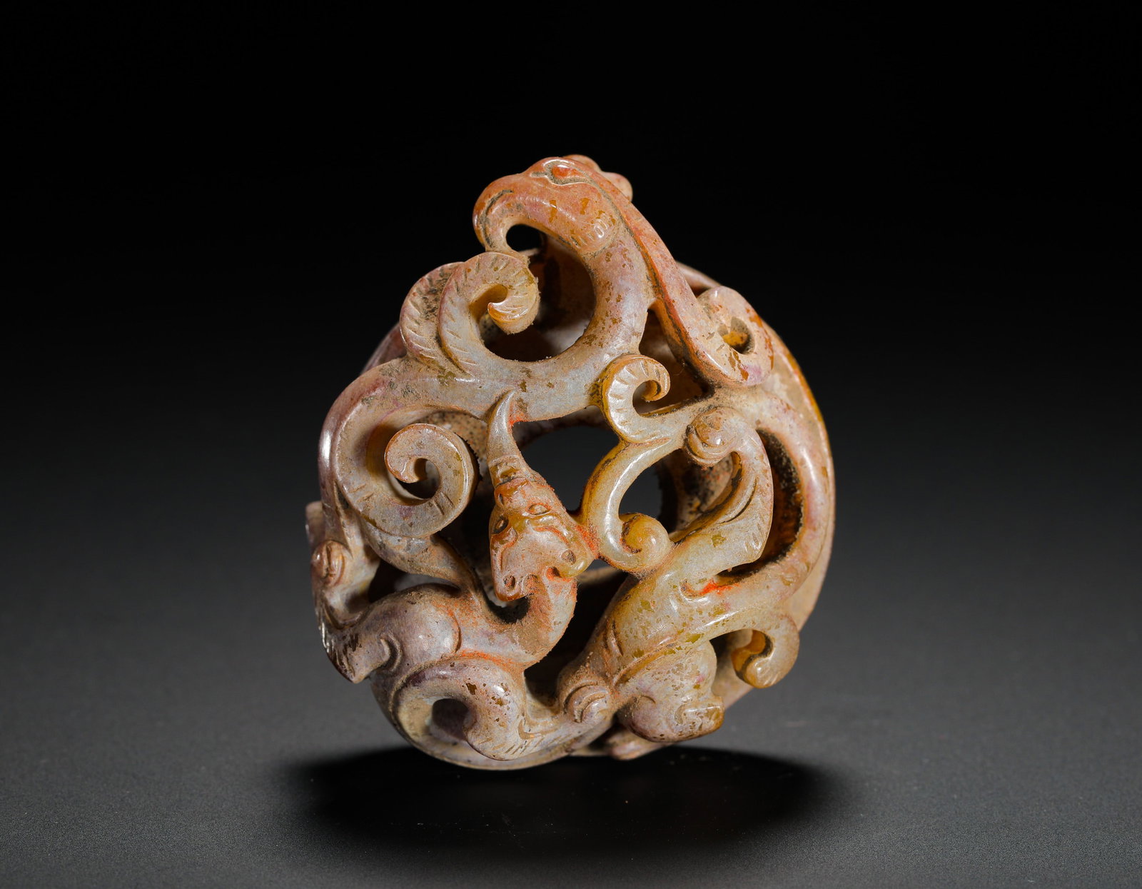 HAN DYNASTY HETIAN JADE DOUBLE-CHI INTERWOVEN JADE PENDANT: Height:2.5cm(0.98in) Width:5.5cm(2.17in) Weight:50g(0.11lb)Han Dynasty hollowed jade ring pendant carved with intertwined twin chi dragons. Solid whole-jade openwork carving with interlocking coiled d