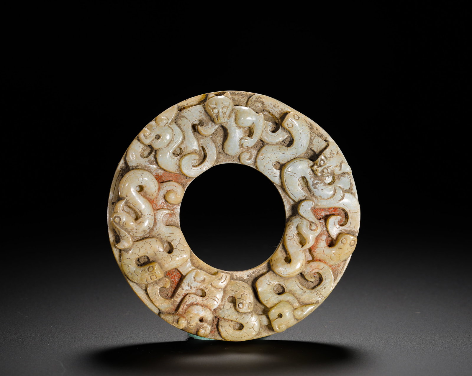 HAN DYNASTY HETIAN JADE GROUP CHI AUSPICIOUS BEAST JADE DISC: D:9cm(3.54in) Weight:140g(0.31lb)Han Dynasty white jade disc with high-relief multi chi dragon carvings. Standard round bi shape, intertwined sacred chi snakes cover the surface, residual vermilion pi