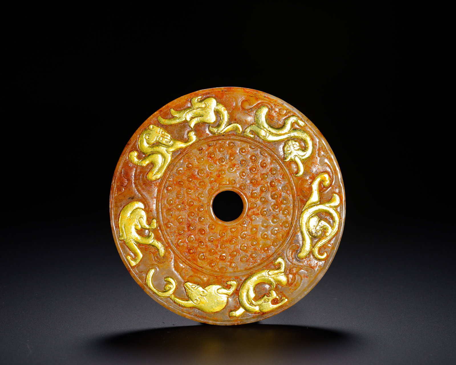 HAN DYNASTY HETIAN JADE CHILONG JADE DISC: D:10cm(3.94in) Weight:100g(0.22lb)Han Dynasty Hetian jade ritual bi disc inlaid with gilt chi dragon plaques. Standard circular jade bi carved with grain nipple patterns in center, seven embossed gold