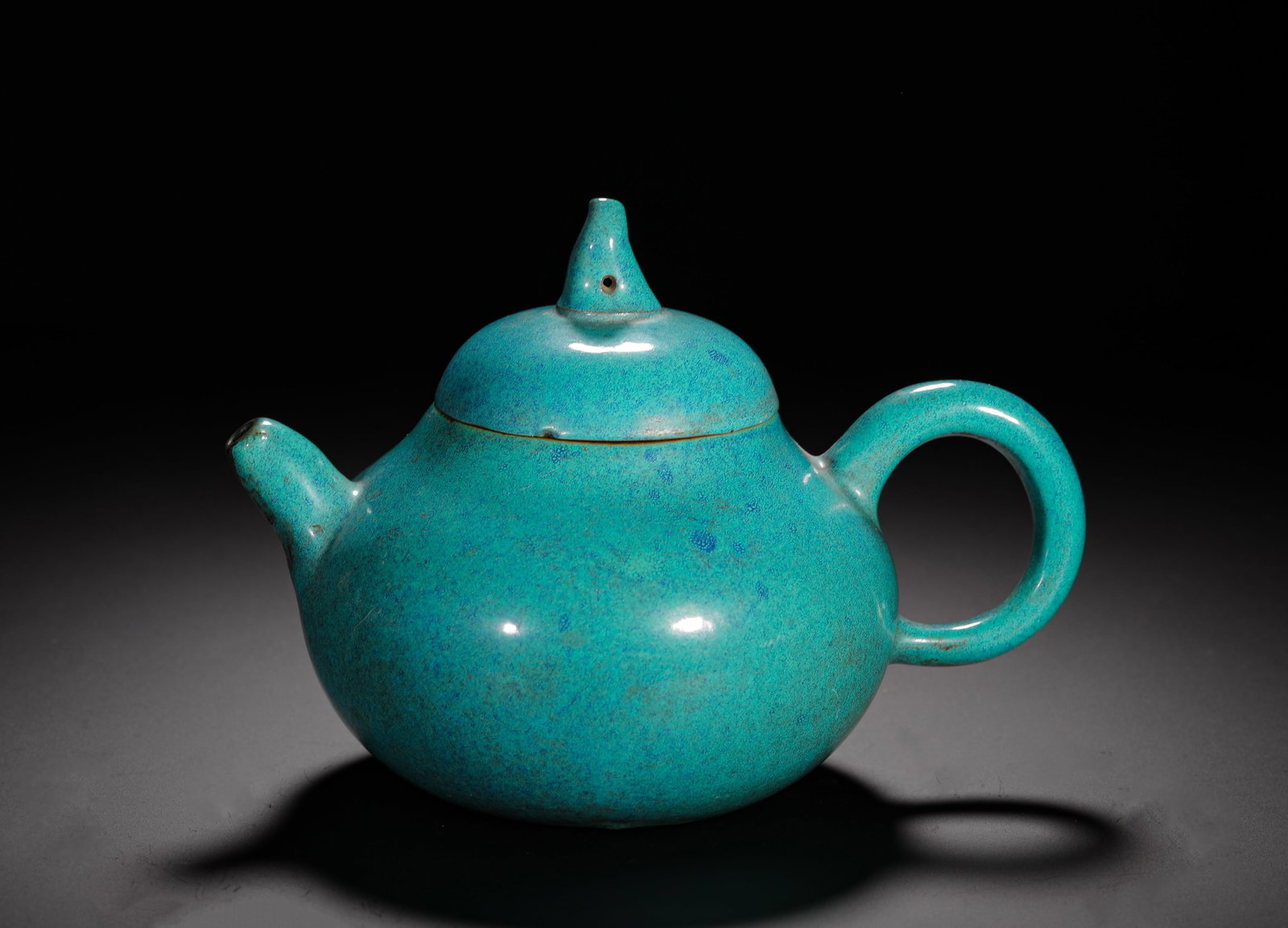 LUJUN GLAZED PEAR-SHAPED PURPLE CLAY TEAPOT: H:12cmW:17cmWeight:420g Classic plain pear-shaped teapot with natural red clay inner body, fully covered with turquoise furnace jun glaze speckled with blue and golden kiln transformation spots. Plump