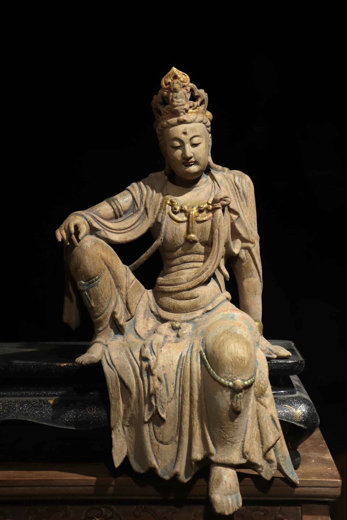SONG DYNASTY WOODCARVING OF THE FREE AND EASY GUANYIN: Height:56cm (22.05in)Wooden Guanyin Bodhisattva statue with gilded ornament, small Buddha on the crown, relaxed sitting posture, residual faded mineral colors, traditional Chinese Buddhist carving.