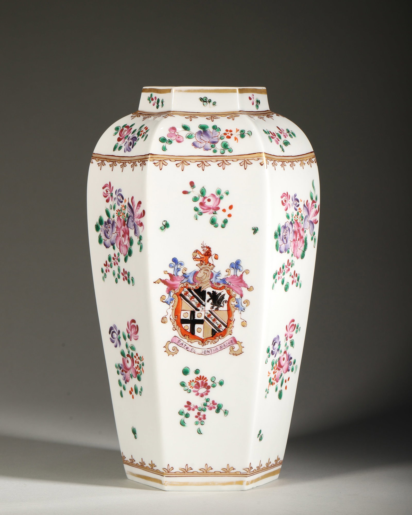 19TH CENTURY FRENCH ARMORIAL PORCELAIN HEXAGONAL VASE WITH FAMILLE ROSE FLORAL DECORATION: H 24cm (9.45 in); W 14cm (5.51 in),Hexagonal porcelain vase with straight neck and tapered base, supported on hexagonal foot. One face painted with a complete European noble armorial achievement, incl