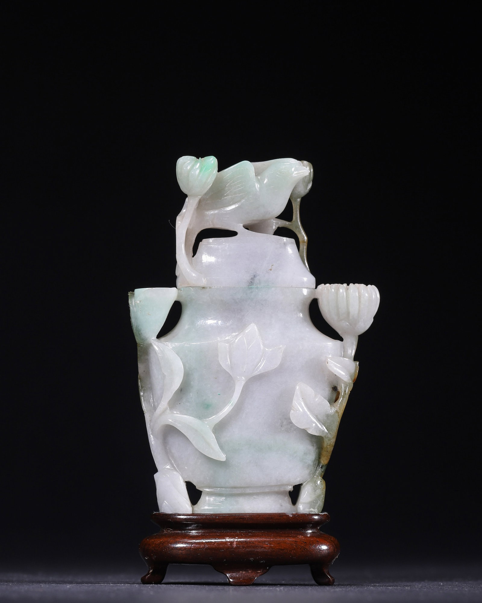 QING DYNASTY JADEITE OPENWORK FLORAL AND BIRD COVERED VASE (1636?C1912 AD): L 7.00cm (2.76 in); W 2.60cm (1.02 in); H 10.00cm (3.94 in); Wt 173.00g (0.38 lb),Qing Dynasty (1636?C1912 AD) covered vase carved from single block of natural jadeite, with original hardwood stand. O
