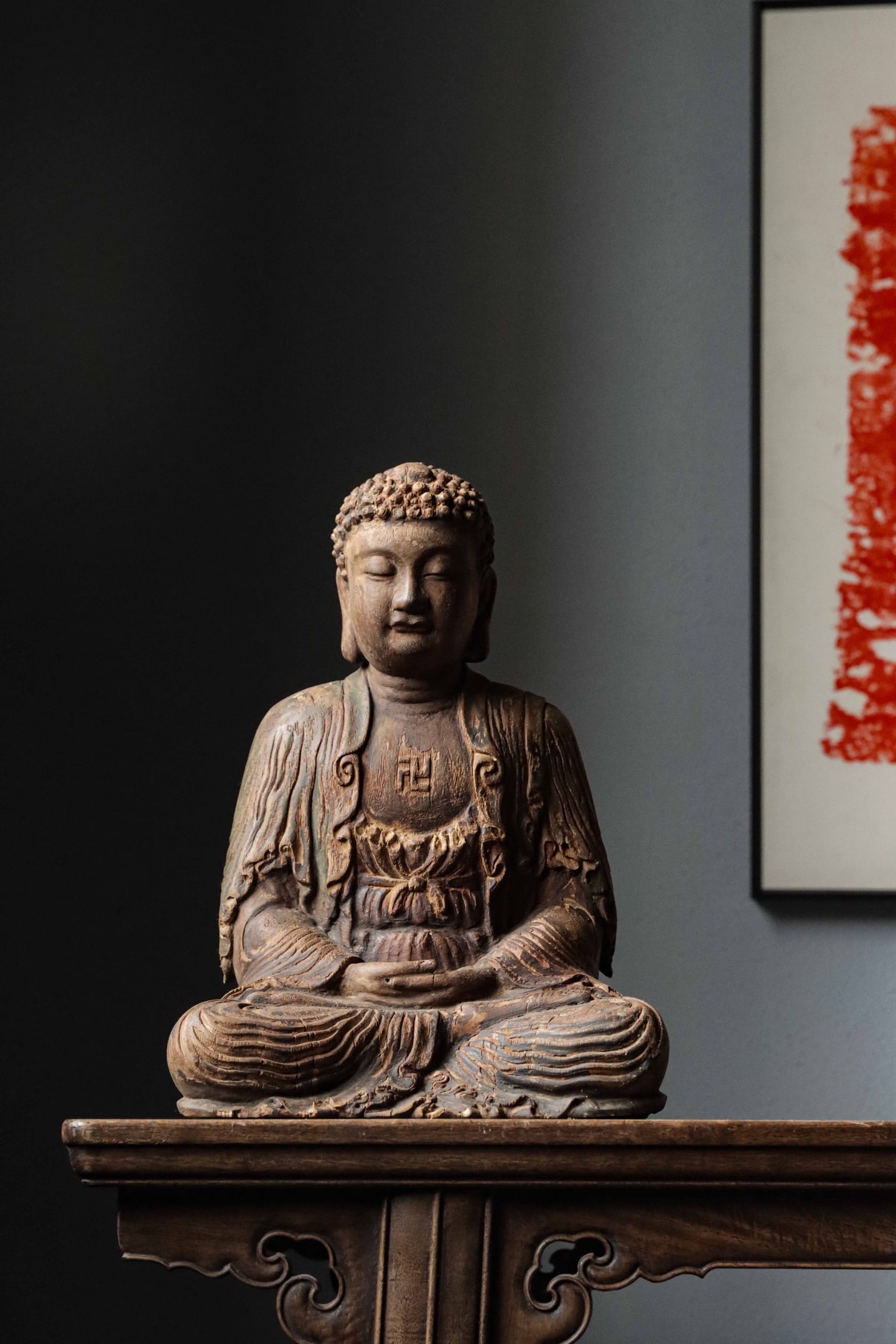 WOODEN SEATED STATUE OF SHAKYAMUNI BUDDHA, MING DYNASTY (1368-1644 AD): H 34cm (13.39 in); W 24cm (9.45 in); D 20cm (7.87 in),Carved from single wood block, Shakyamuni seated in full lotus posture with hands in dhyana mudra. Well-defined spiral hair, serene merciful facia
