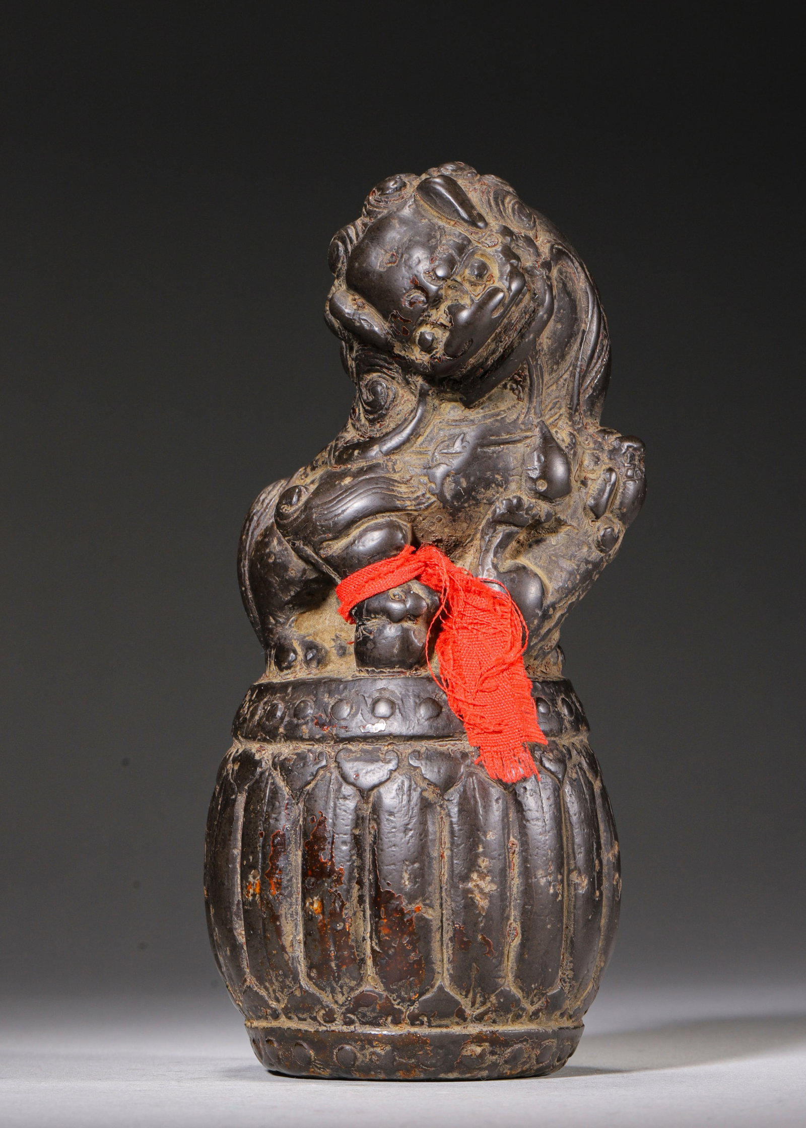 STONE ORNAMENT WITH LION AND CUB ON DRUM BASE, QING DYNASTY (1644-1912 AD): L 7cm (2.76 in); W 7cm (2.76 in); H 17cm (6.69 in); Wt 1180g (2.601 lb),Carved from a single stone, coated with black lacquer with partial natural lacquer loss. The melon-fluted drum base is