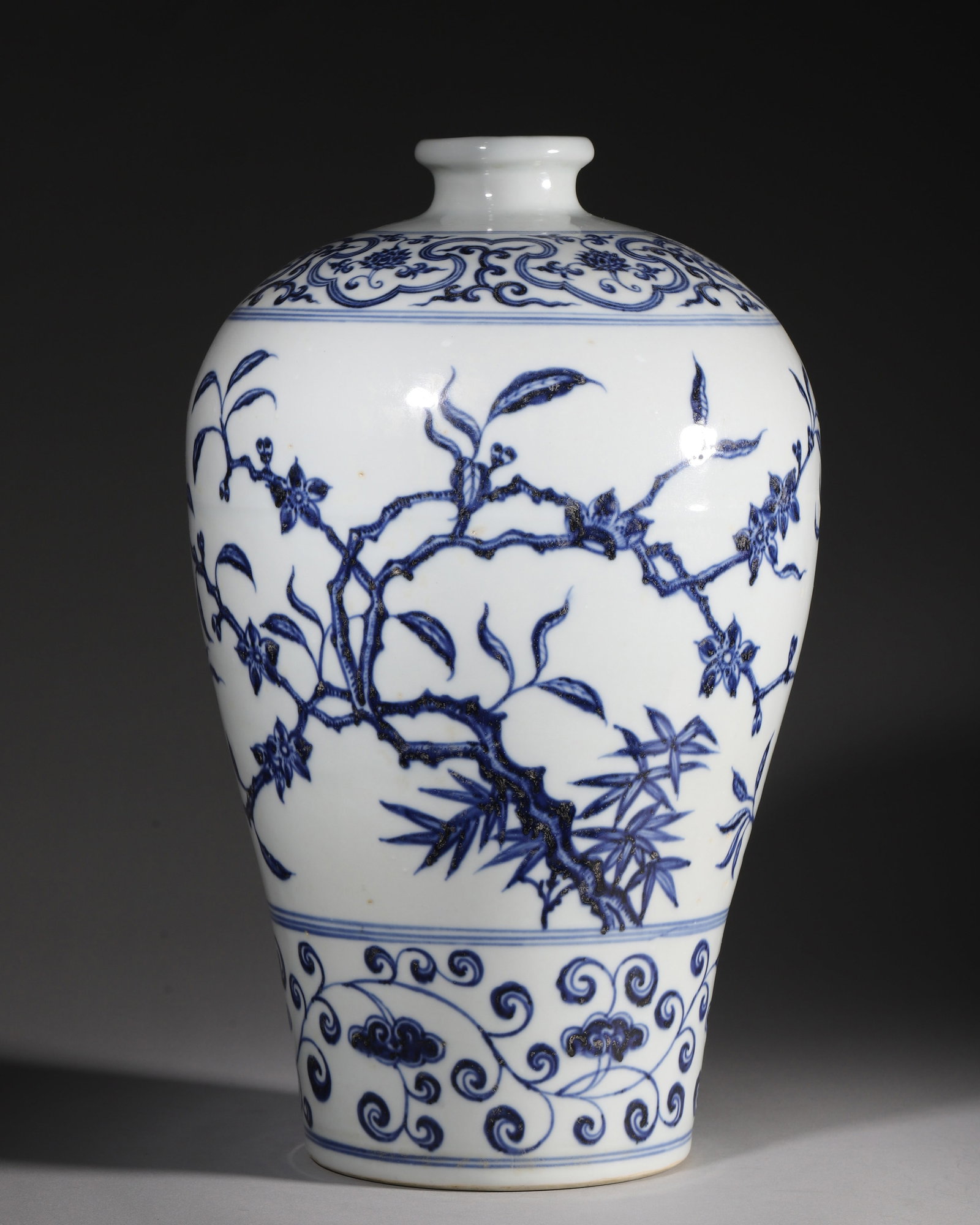A BLUE AND WHITE MEIPING VASE WITH PEACH BLOSSOM AND BAMBOO, XUANDE PERIOD, MING DYNASTY: L 22cm (8.66 in); H 38cm (14.96 in),Ming Xuande blue and white meiping with small flared mouth and tapered lower body. Decorated in horizontal bands: shoulder adorned with ruyi cloud collar interwoven