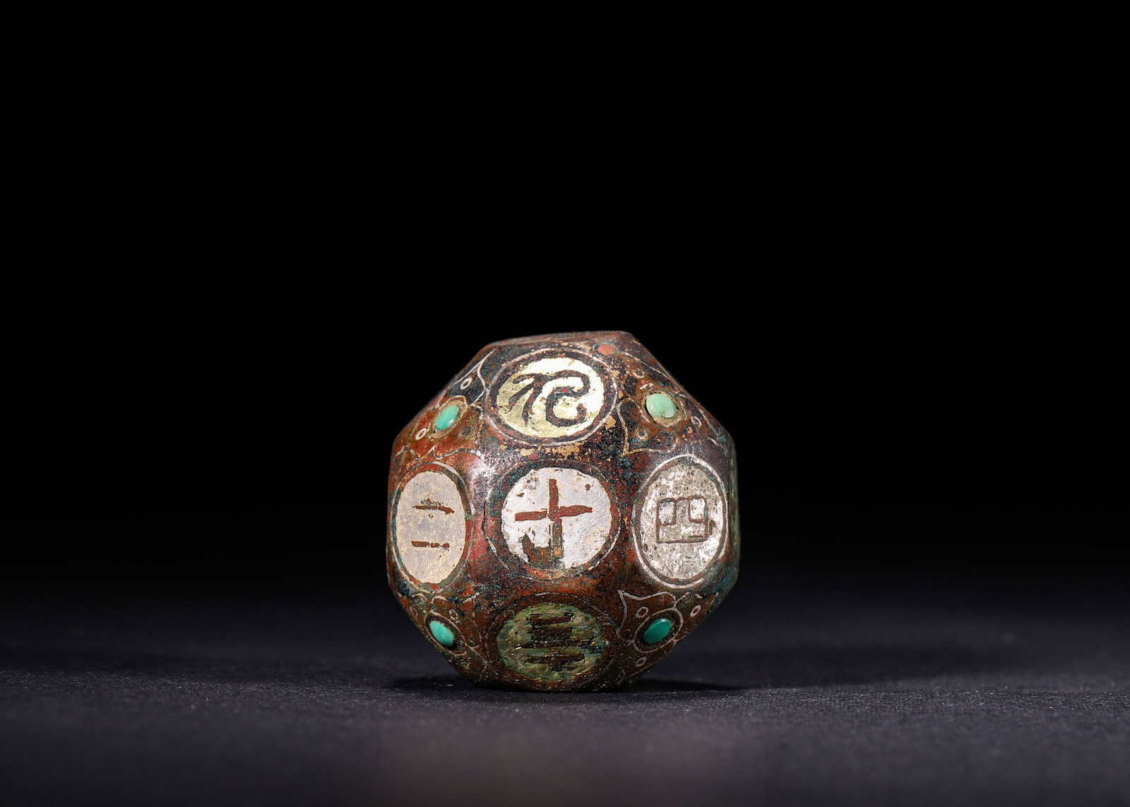 BRONZE EIGHTEEN-SIDED DRINKING GAME DICE INLAID WITH TURQUOISE AND GOLD & SILVER INLAY, HAN DYNASTY: W 3.7cm (1.46 in); Wt 151g (0.33 lb),Cast bronze eighteen-sided dice. Each facet is decorated with gold and silver chased numerals and drinking-game inscriptions within circular frames, and turquoise 