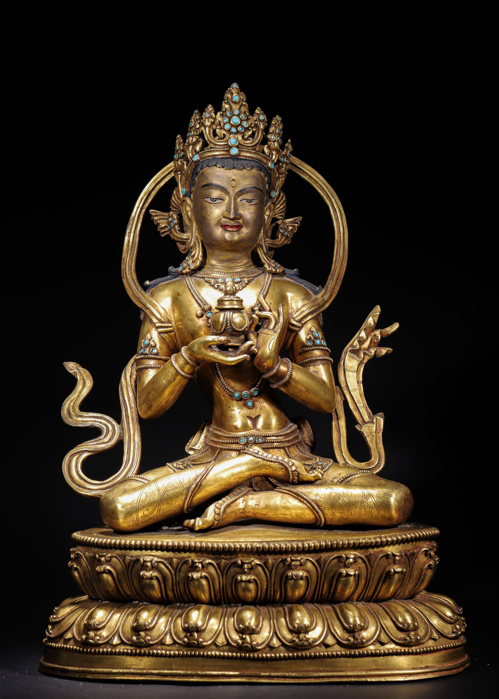GILT BRONZE AMITAYUS SEATED FIGURE, QING DYNASTY (1644-1912 AD): L 32cm (12.598 in); W 23cm (9.055 in); H 44cm (17.32 in); Wt 10.8kg (23.81 lb),Cast copper fully gilded. Amitayus wears jewelled crown with serene facial features, seated in padmasana. Cupping longevi