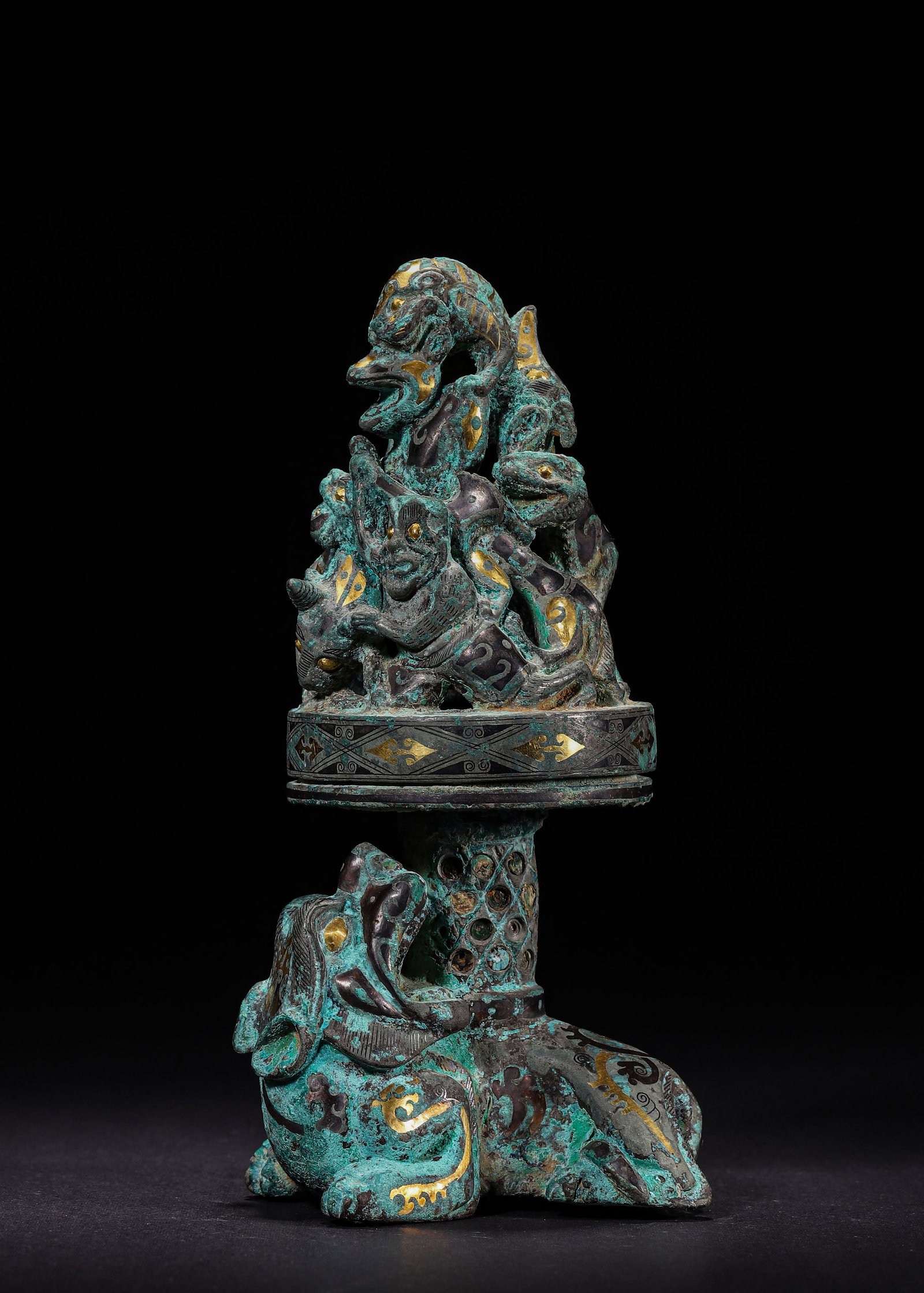 ASSEMBLED BRONZE CENSER WITH HUNTING AND BEAST MOTIFS INLAID WITH GOLD AND SILVER, HAN DYNASTY (202: L 8cm (3.15 in); W 6cm (2.36 in); H 17cm (6.69 in); Wt 1097g (2.42 lb),This piece consists of a base and an incense cover. The base features a recumbent beast supporting an openwork column, with a cir