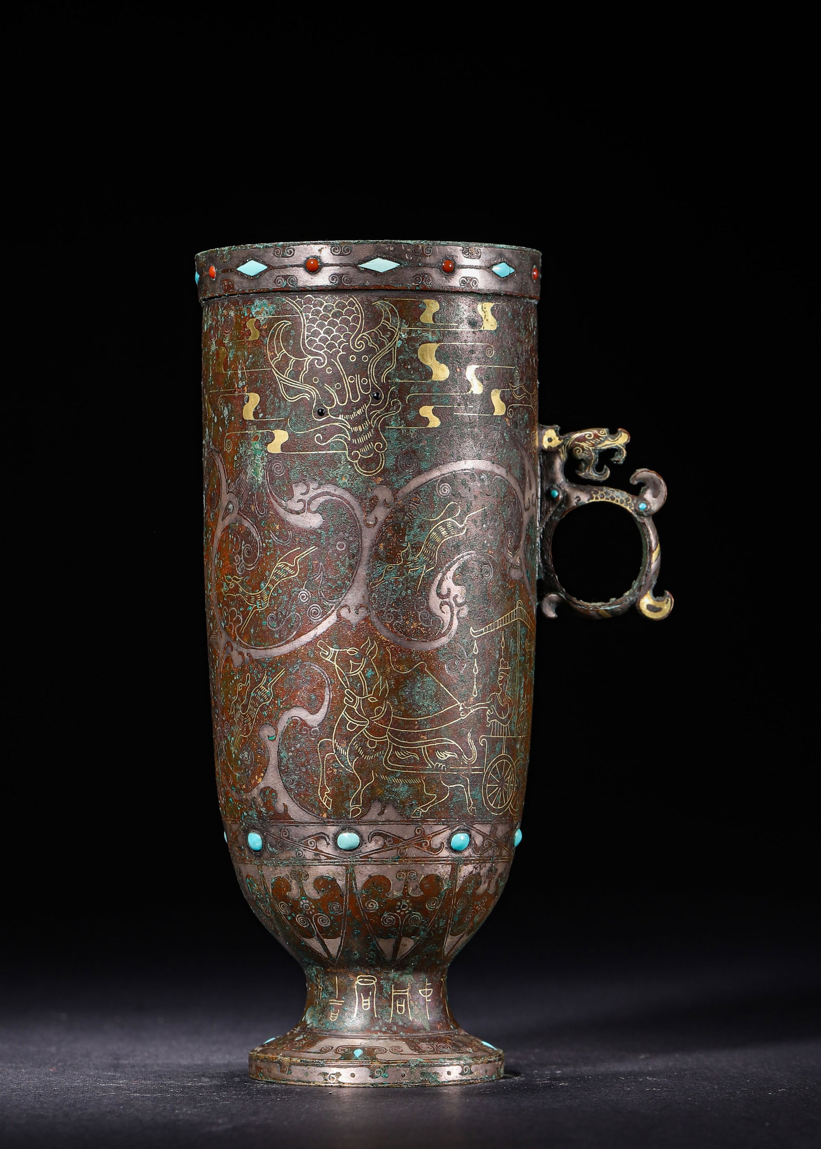 BRONZE SINGLE-HANDLED STEMMED CUP INLAID WITH GOLD, SILVER AND TURQUOISE, HAN DYNASTY (202 BC?C220: L 10cm (3.94 in); W 7cm (2.76 in); H 17cm (6.69 in); Wt 641g (1.41 lb),Bronze stemmed cylindrical cup with dragon-head loop handle. The surface is decorated with chariot procession, beasts and birds o