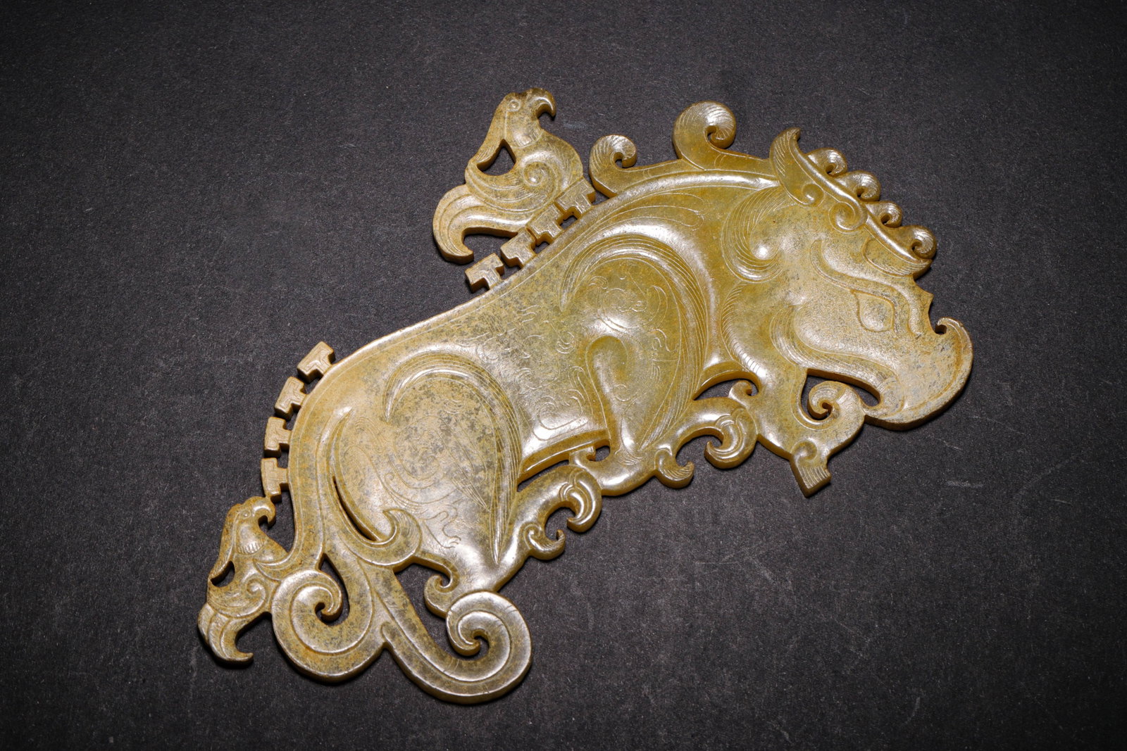 YELLOW JADE OPENWORK PENDANT WITH MYTHICAL BEAST AND PHOENIX MOTIFS, WARRING STATES PERIOD (475: L 15cm (5.91 in); W 9cm (3.54 in); Wt 100g (0.22 lb),Carved from Hetian yellow jade with elegant ancient patina. Openwork pendant featuring a side-striding mythical beast. Phoenixes are incised upon i