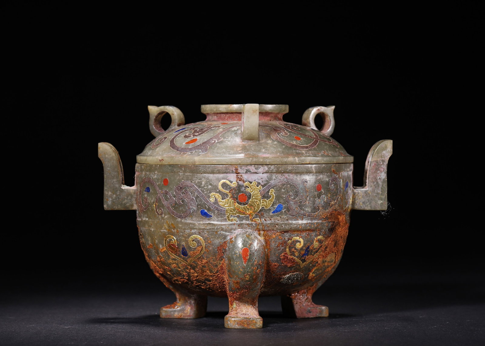 CELADON JADE TRIPOD COVERED DING WITH TWIN HANDLES INLAID WITH GOLD, SILVER AND GEMSTONES, HAN: L 15cm (5.91 in); W 11cm (4.33 in); H 11cm (4.33 in); Wt 538g (1.19 lb),Carved from Hetian celadon jade, this tripod covered ding features square twin handles and three ring knobs together with a cent