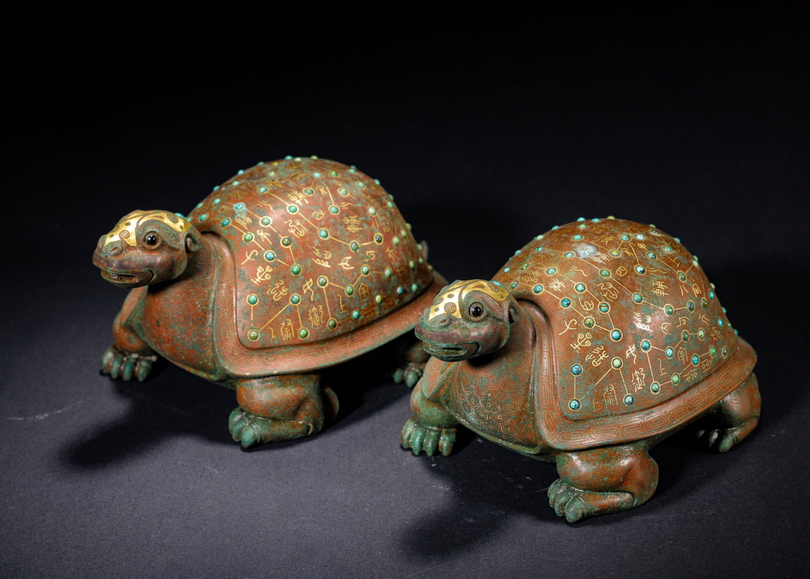 PAIR OF BRONZE TORTOISES WITH GOLD INLAY AND TURQUOISE INLAYS, WARRING STATES PERIOD (475-221 BC): H 9cm (3.54 in); L 15cm (5.91 in); W 9cm (3.54 in); Wt 1559g (3.44 lb),A matched pair of cast bronze tortoises. The heads bear gold inlaid ornamentation. Carapaces feature star charts delineated by go