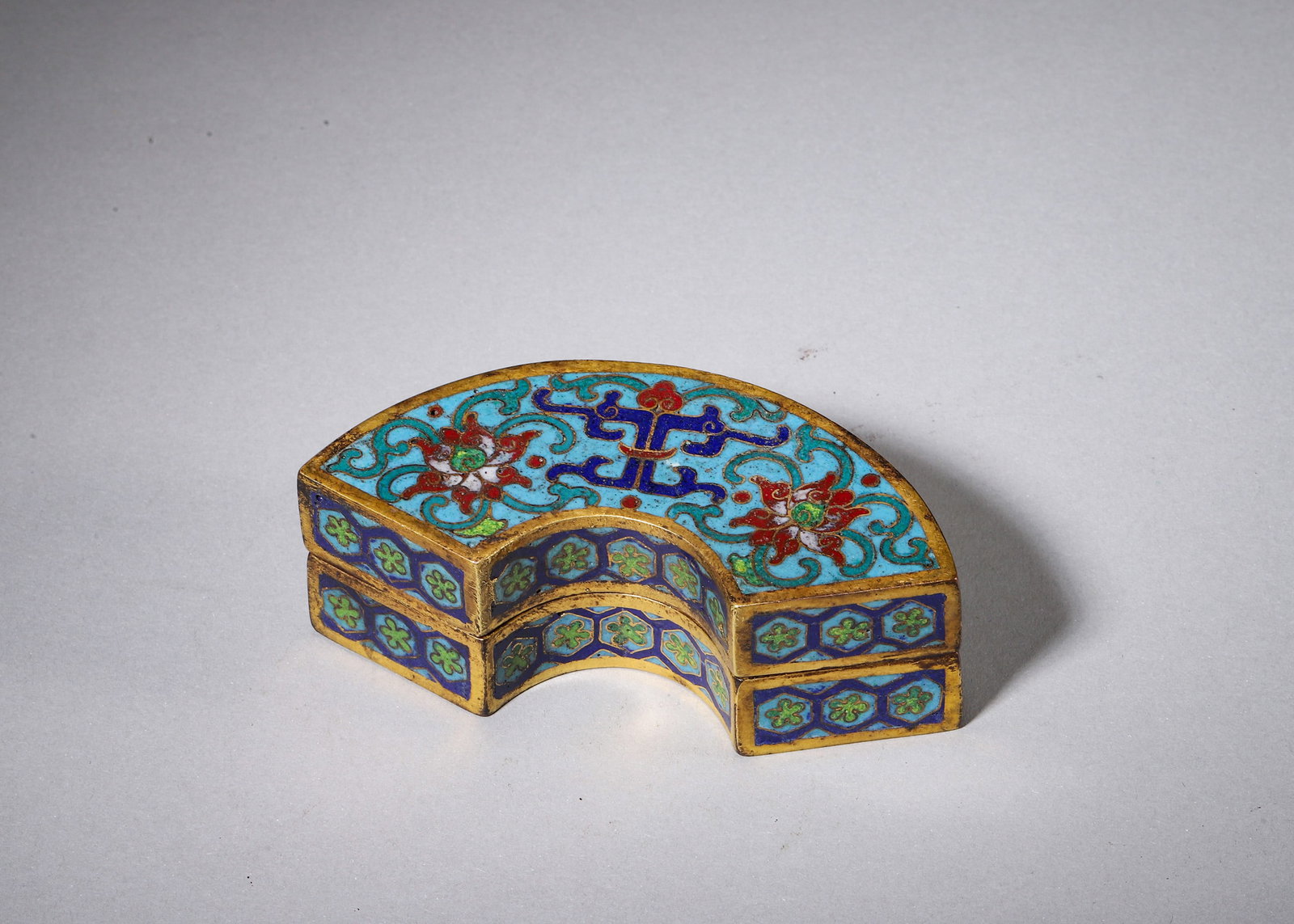 QIANLONG PERIOD GILT COPPER CLOISONNE FAN-SHAPED INK PASTE BOX: L 9.00cm (3.54 in); W 3.50cm (1.38 in); H 3.00cm (1.18 in); Wt 158.00g (0.35 lb),Gilt copper fan-shaped two-part covered box for ink paste storage.The lid top is decorated with turquoise ground cloiso