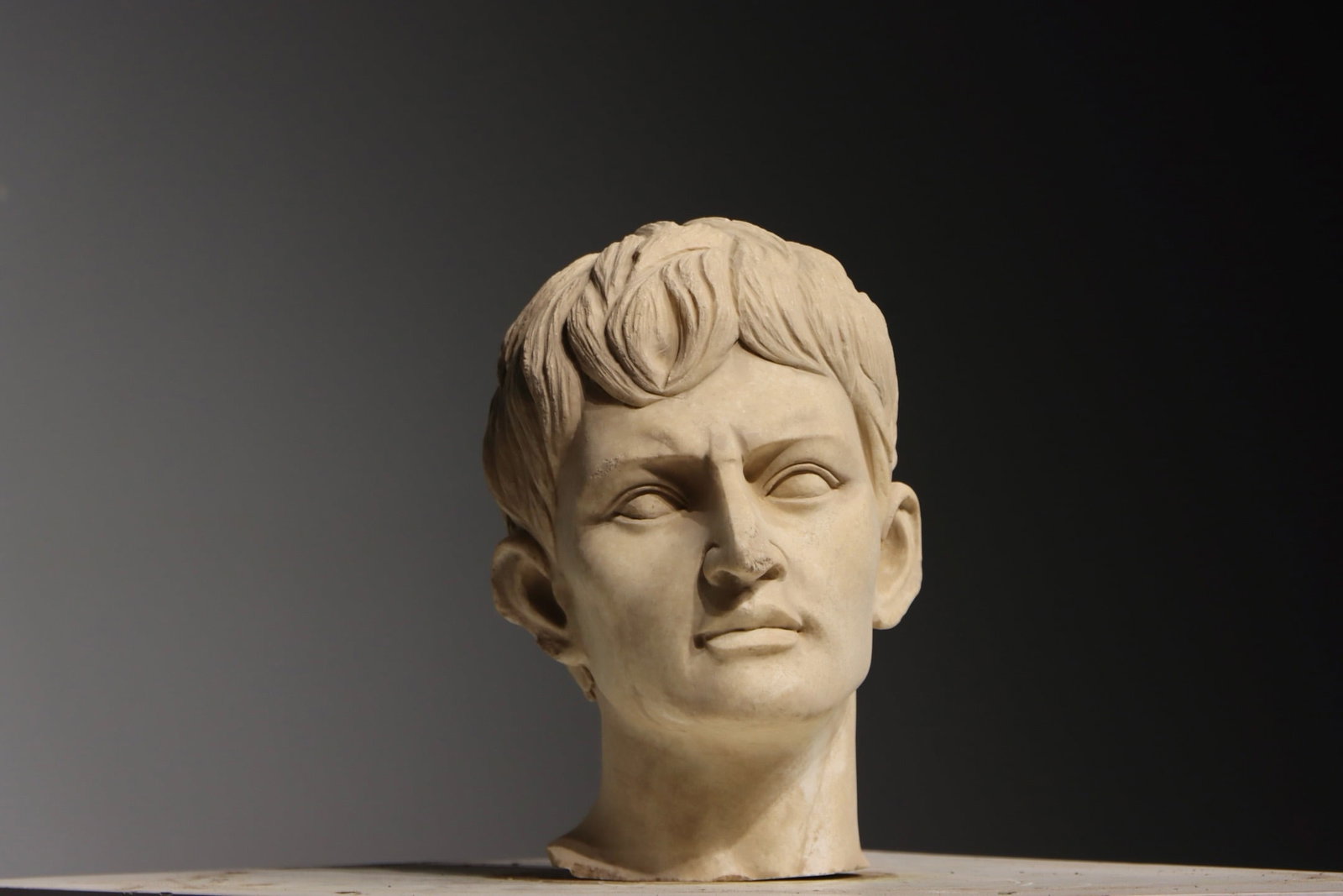 WHITE MARBLE HEAD OF EMPEROR AUGUSTUS(2?C3 ???? AD): H 32cm (12.598 in),Carved from white marble, depicting the Roman Emperor Augustus. The hair is meticulously sculpted with distinct layered and flowing textures following classical Roman prototypes. Th