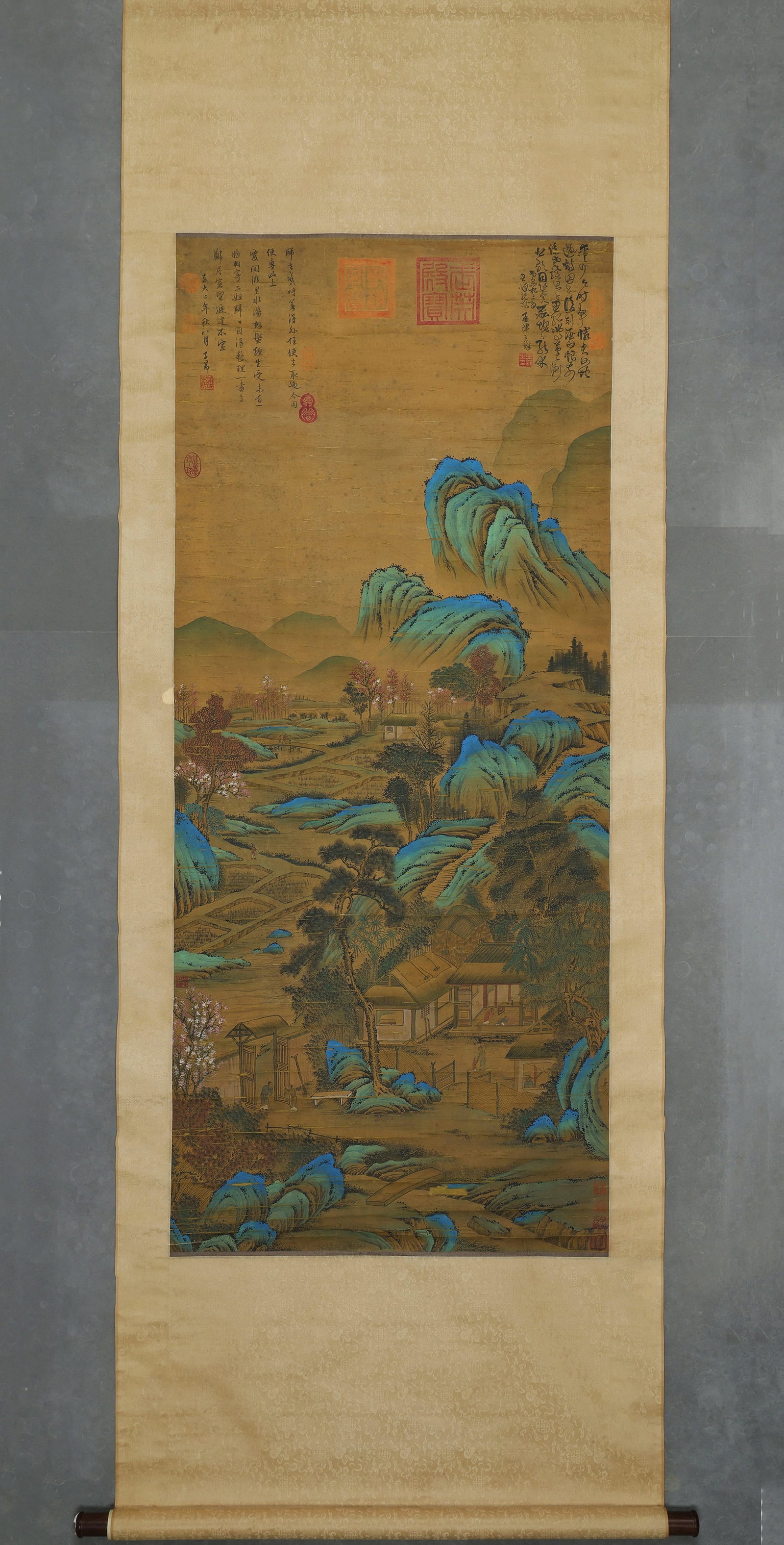 ZHAO MENGFU, GREEN-AND-BLUE LANDSCAPE OF RURAL MOUNTAIN DWELLING, COLOUR ON SILK, HANGING SCROLL,: Image L 143cm (56.299 in) x Image W 64cm (25.197 in),Grand green-and-blue landscape painted on silk, depicting a serene Jiangnan countryside dwelling scene. Rolling peaks are rendered with rich azurit