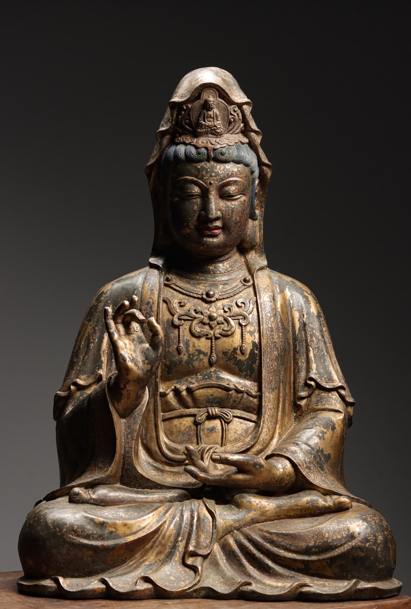 LACQUERED GILT BRONZE SEATED GUANYIN, QING DYNASTY, 1644?C1912 AD: Wt 21000g (46.297 lb); H 66cm (25.98 in); L 45cm (17.72 in); W 35cm (13.78 in),Bronze Guanyin with lacquer gilding. Seated in full lotus position, crowned with an Amitabha effigy. Serene facial featur