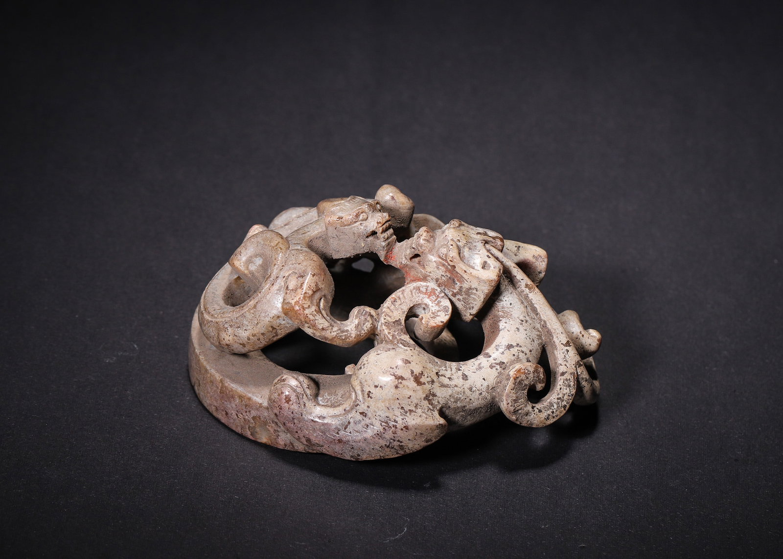 OPENWORK ANCIENT JADE CIRCULAR PENDANT WITH TWIN CHILONG, HAN DYNASTY (202 BC?C220 AD): L 9.00cm (3.54 in); W 6.50cm (2.56 in); H 5.00cm (1.97 in); Wt 160.00g (0.35 lb),Solid carved ancient jade circular pendant with multi-layer openwork of two intertwined chilong serpents. Coiled dragon