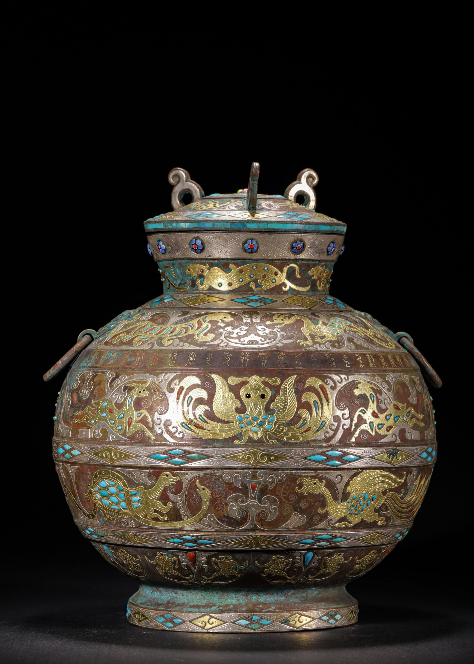 BRONZE COVERED HU WITH GOLD & SILVER INLAY, TURQUOISE INLAY AND BEAST-HEAD HANDLES, WARRING STATES: H 26cm (10.24 in); D 22cm (8.66 in); Wt 3316g (7.31 lb),Cast bronze covered hu with original lid, slender neck and rounded belly, fitted with beast-head handles and movable rings. The surface is decor