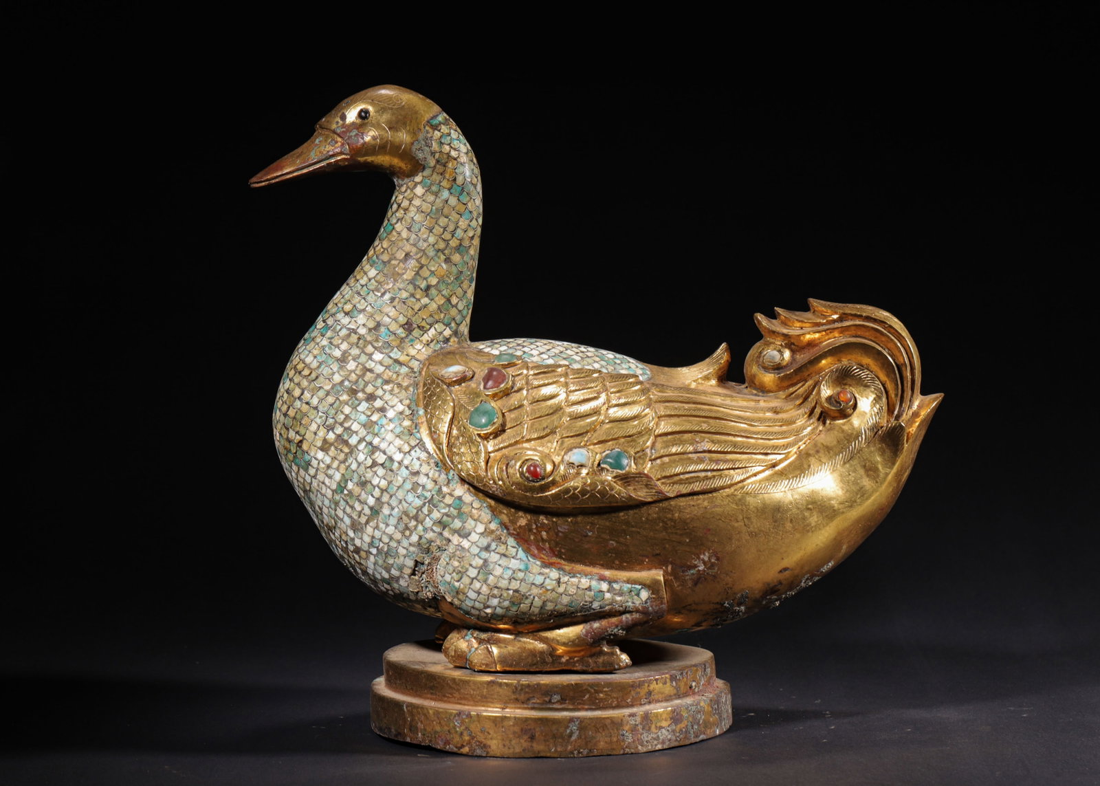 GILT BRONZE WILD GOOSE CENSER INLAID WITH TURQUOISE AND GEMSTONES, HAN DYNASTY (202 BC?C220 AD): H 33cm (12.99 in); L 35cm (13.78 in); W 21cm (8.27 in); Wt 6337g (13.97 lb),Gilt bronze censer modelled as a standing wild goose set on a circular plinth. The neck and body are densely inlaid with tur