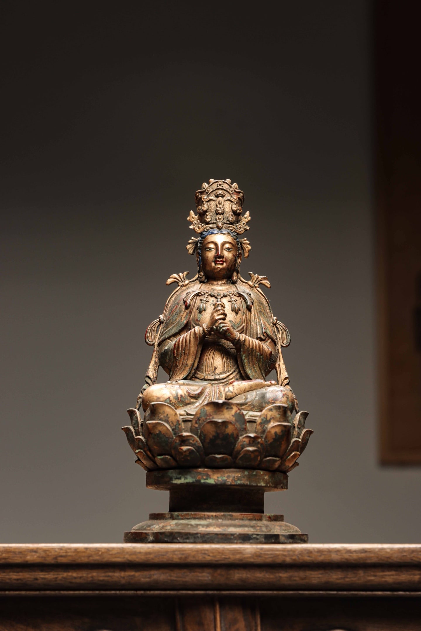 GILT LACQUERED BRONZE VAIROCANA, QING DYNASTY, 1644?C1912 AD: Wt 2600g (5.73 lb); H 25cm (9.84 in); W 12.5cm (4.92 in); D 12.5cm (4.92 in),Bronze figure with lacquer gilding and polychrome pigments. Vairocana sits in full lotus posture upon a tall lotus throne, 