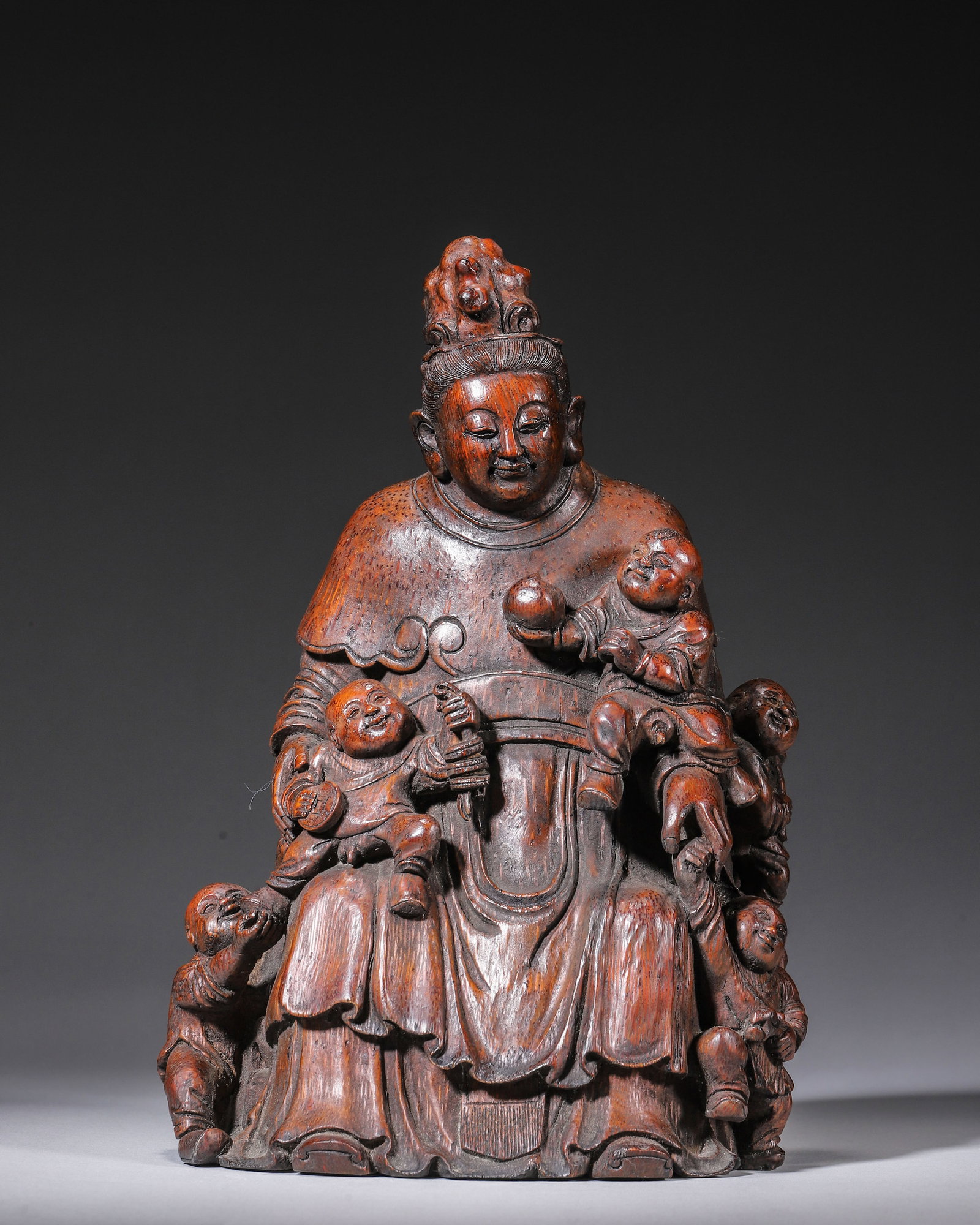 QING DYNASTY BAMBOO ROOT CARVED FIVE BOYS GUANYIN, SIGNED YU HONGKAI: L 15.00cm (5.91 in); W 12.00cm (4.72 in); H 22.00cm (8.66 in); Wt 517.00g (1.14 lb),Carved from single aged bamboo root with antique reddish-brown patina. Guanyin wears an ornate coiffure with mild me