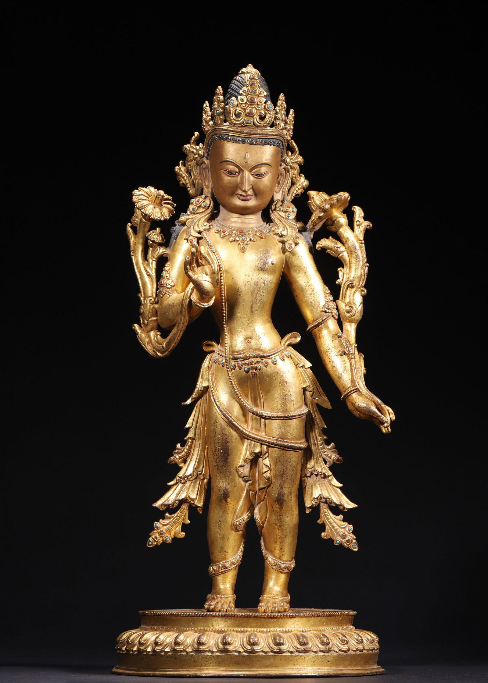 GILT BRONZE PADMAPANI BODHISATTVA STANDING FIGURE, QING DYNASTY (1644-1912 AD): L 22.00cm (8.66 in); W 22.00cm (8.66 in); H 47.00cm (18.50 in); Wt 6964.00g (15.35 lb),Cast in fine copper fully gilded, crown and jeweled necklaces inlaid with red and blue cabochons. High coiled hai