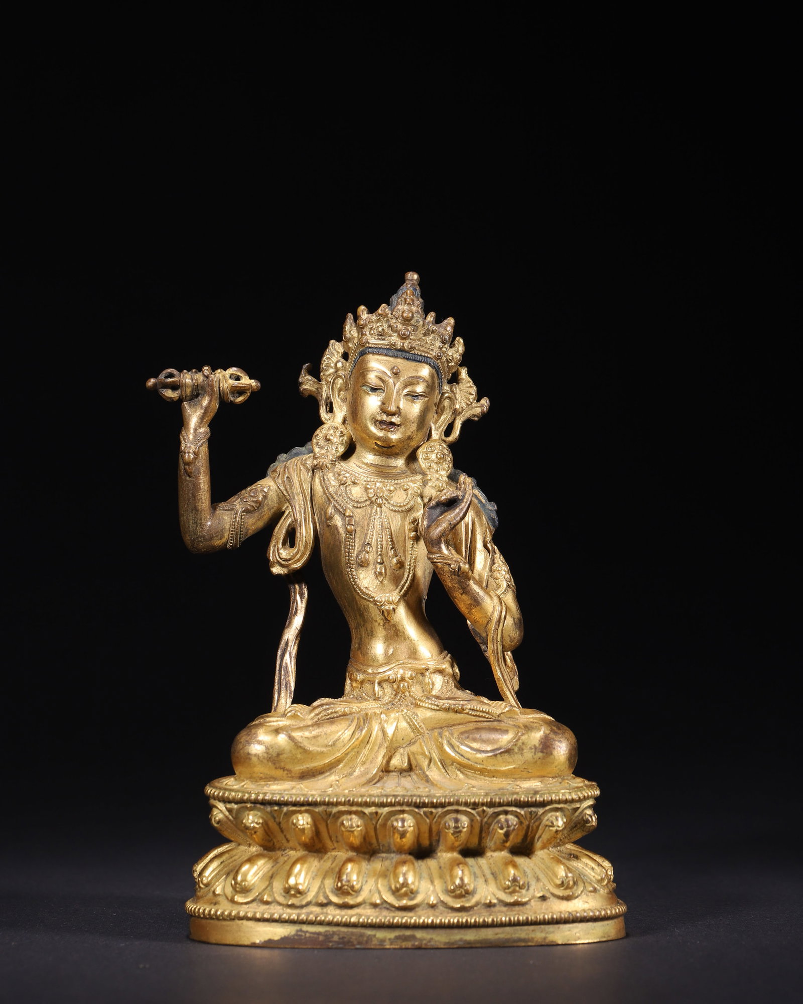 GILT BRONZE SEATED VAJRAPANI, MING DYNASTY (1368-1644): L 8.50cm (3.35 in); W 6.00cm (2.36 in); H 13.00cm (5.12 in); Wt 596.00g (1.31 lb),Gilt bronze Vajrapani seated in lotus posture on double lotus base. The deity holds vajra in right hand, adorned with 