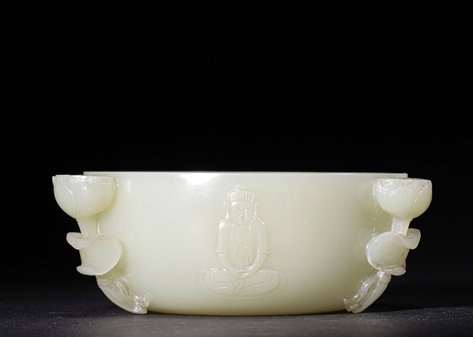 HETIAN WHITE JADE BUDDHIST WATER VESSEL WITH LOTUS AND BUDDHA MOTIFS, QING DYNASTY (1636-1912 AD): H 4cm (1.57 in); D 10cm (3.94 in); Wt 195g (0.43 lb),Carved from Hetian white jade with smooth, subtle luster. Rounded bowl-shaped vessel, decorated with relief seated Buddha in meditation pose. Three