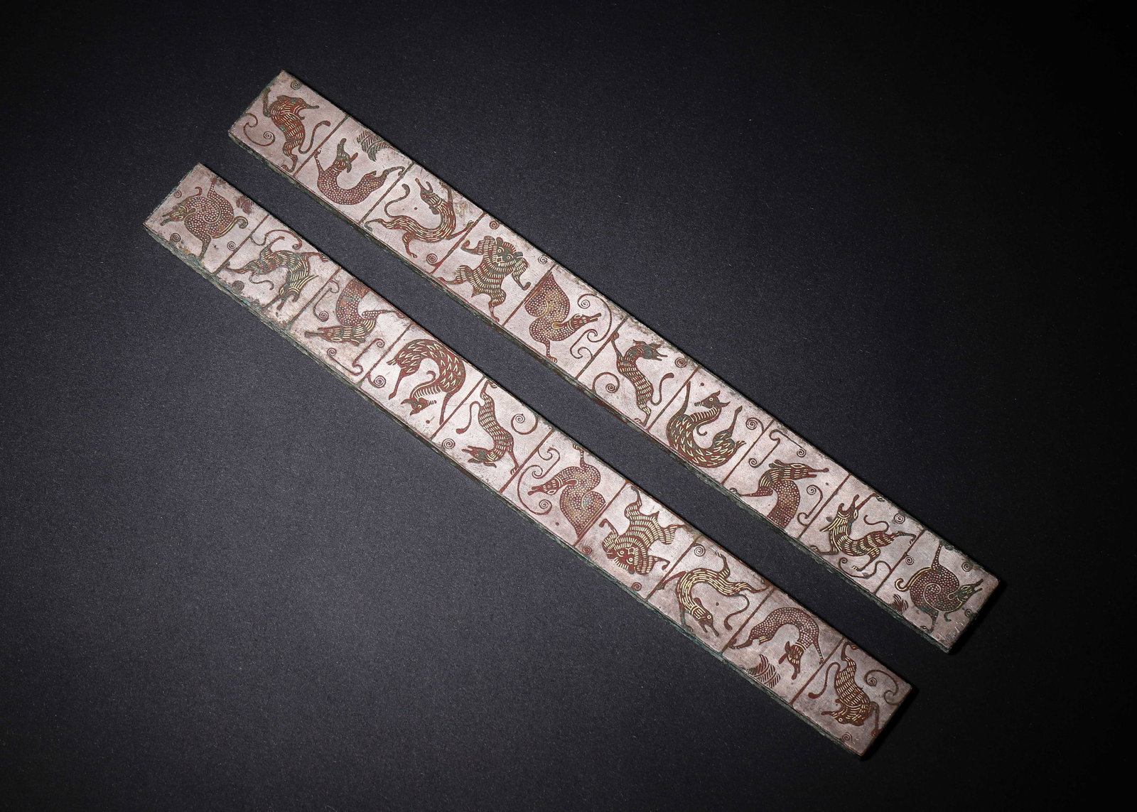 PAIR OF BRONZE RULERS WITH GOLD & SILVER INLAID AUSPICIOUS BEASTS, HAN DYNASTY (202 BC-220 AD): L 23cm (9.055 in); W 2.3cm (0.91 in); Wt 428g (0.94 lb),A matched pair of bronze rulers. The obverse is divided into panels with gold and silver chased auspicious beasts and birds. The reverse bears g