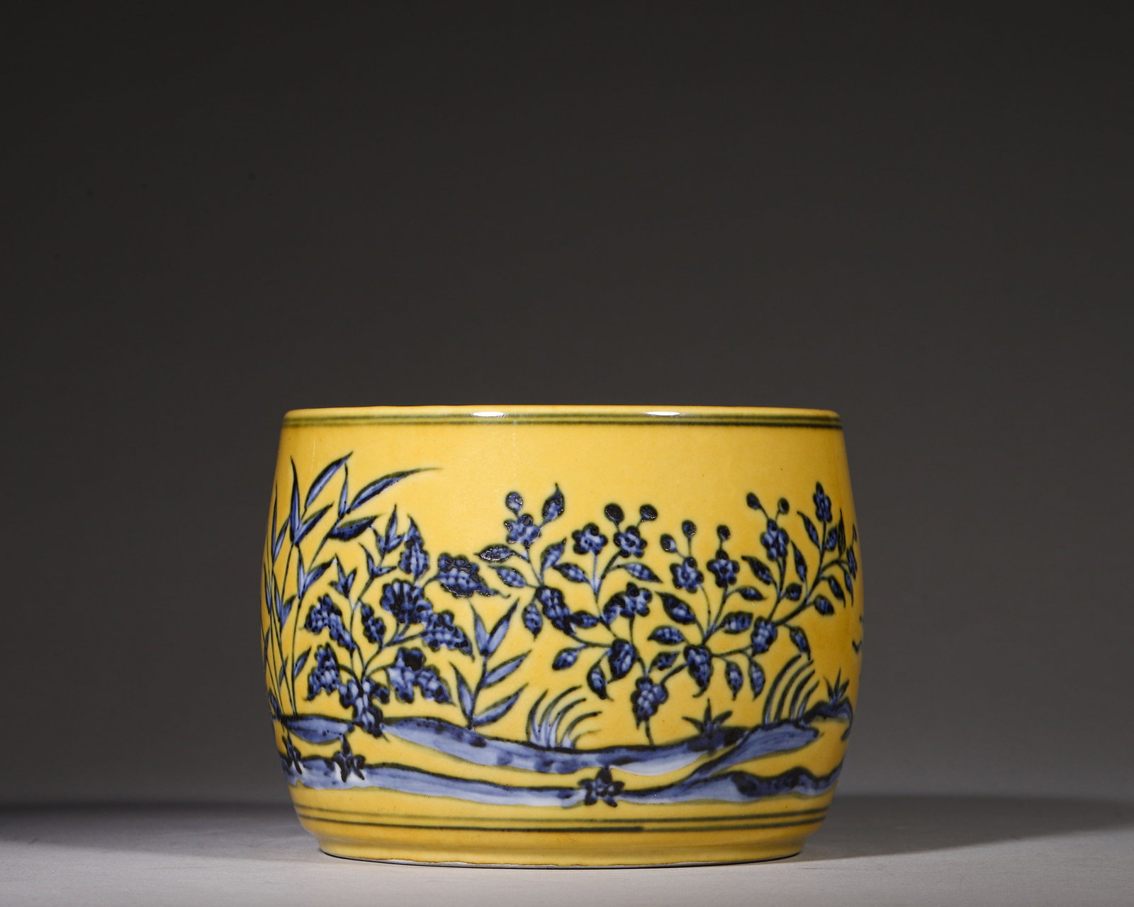 Yellowground Underglaze Blue Cricket Jar With Wild Goose Motifs, Xuande Ming (14261435 Ce): W 14cm (5.51 in); H 10cm (3.94 in)Drumshaped cricket jar with original cover. Yellow ground decorated in underglaze blue with continuous scene of wild geese, bamboos, rocks and aquatic plants. Xuande 