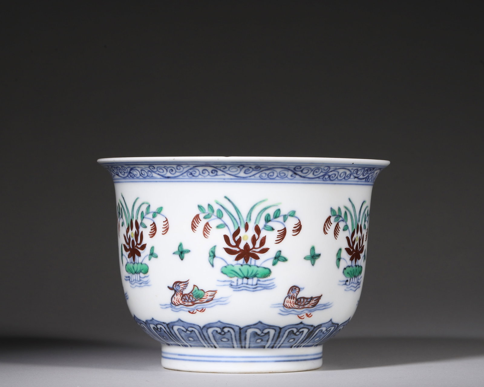 Doucai Bellshaped Bowl With Mandarin Ducks And Lotus Pond, Chenghua Period Ming Dynasty (14651487: W 14cm (5.51 in); H 10cm (3.94 in)Bellshaped form, flared rim, deep curved body, ring foot. Outer rim painted with blue scrolling vines. Exterior decorated with mandarin ducks amid lotus pond. Lower b