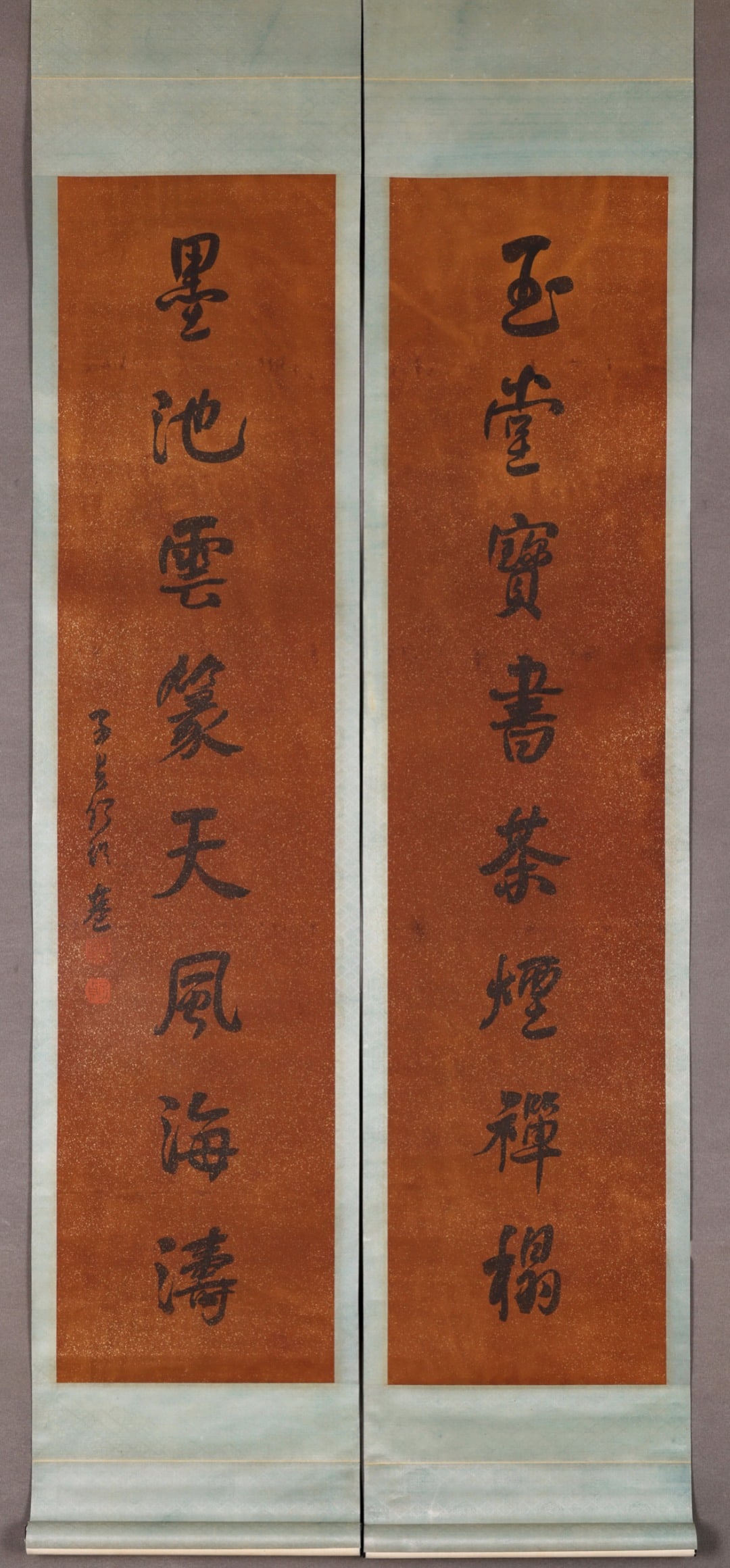 Seven Character Calligraphy Couplet, After He Shaoji, Qing Dynasty (1644 1912): Image L 125cm (49.21 in) Image W 28.5cm (11.22 in) (2 pieces)Running script couplet on gold speckled red wax paper, pair of hanging scrolls. Inscribed seven character verse, signed and sealed. Gold fl